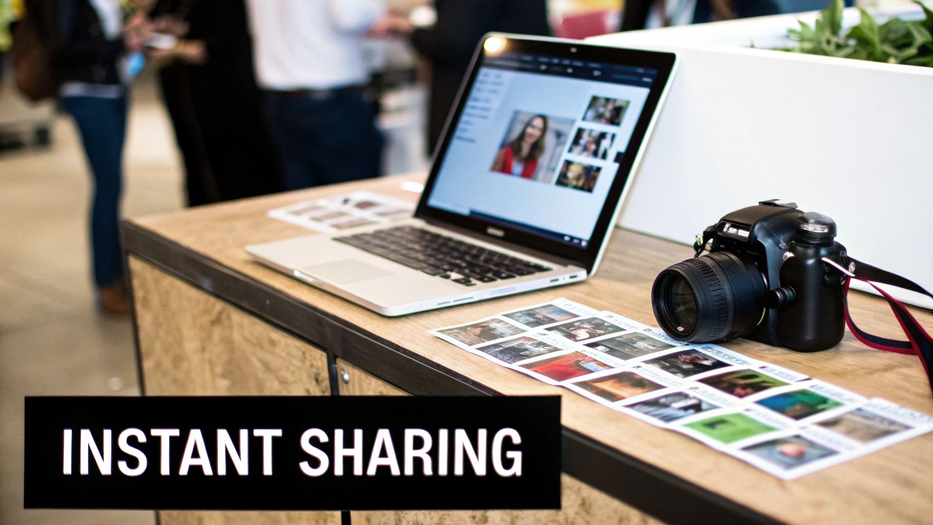 A laptop and DSLR camera on a wooden table next to printed photos, with an 'Instant Sharing' sign.