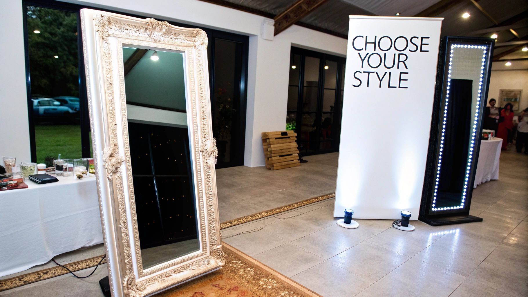 Two interactive photo booth mirrors, one white ornate and one black with LEDs, at an event with a 'Choose Your Style' banner.