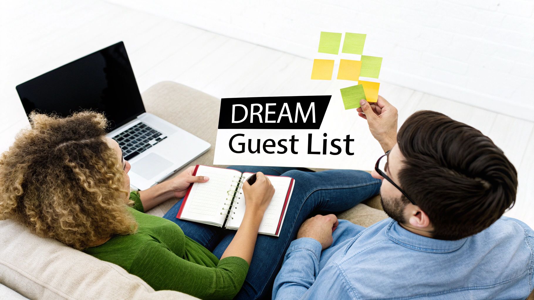 Couple smiling and planning their wedding guest list together.