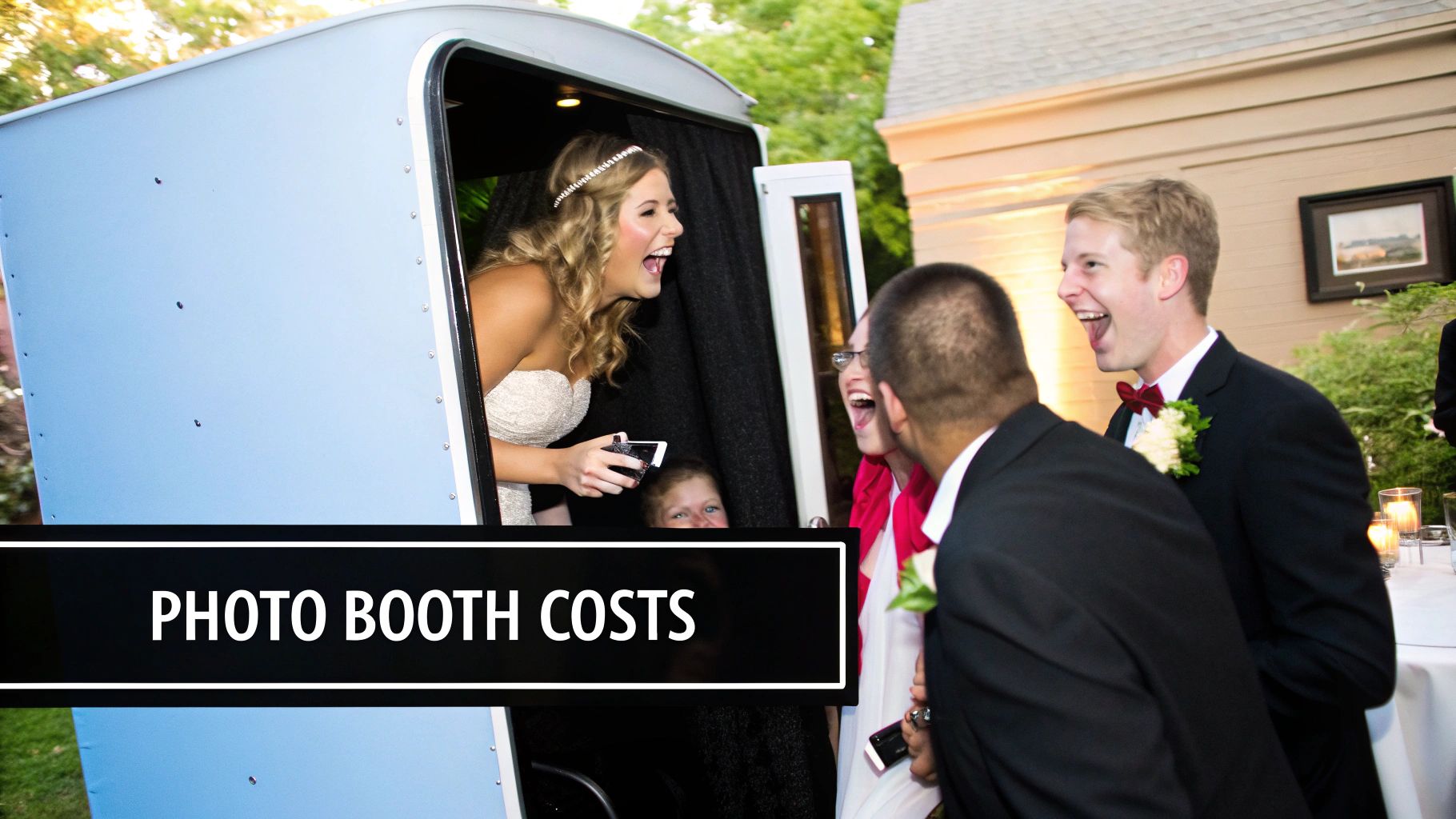 A stylish, modern photo booth set up at a wedding reception with guests posing.