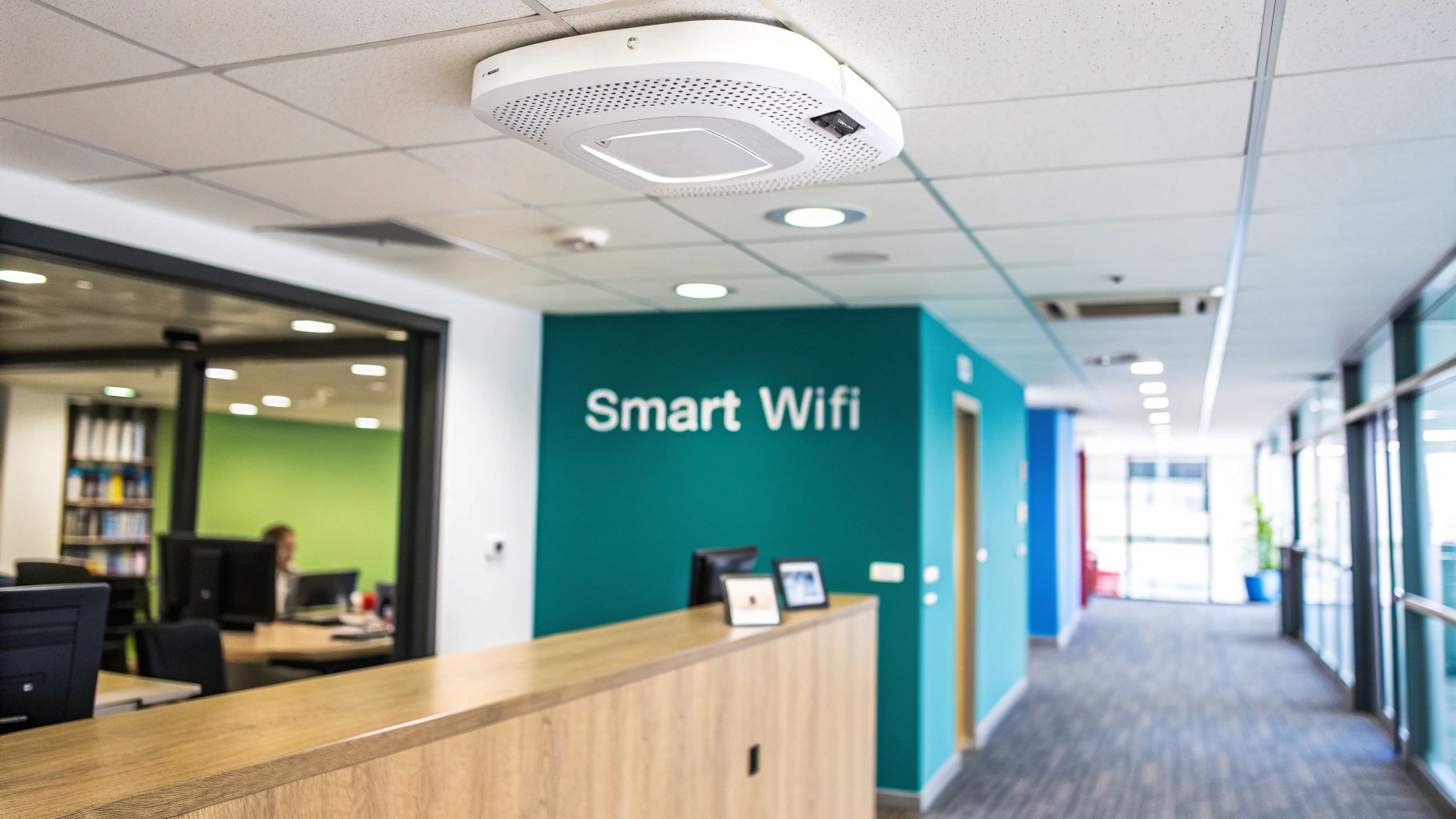 White Meraki access point mounted on a ceiling tile in a bright, modern office entrance with a reception area.