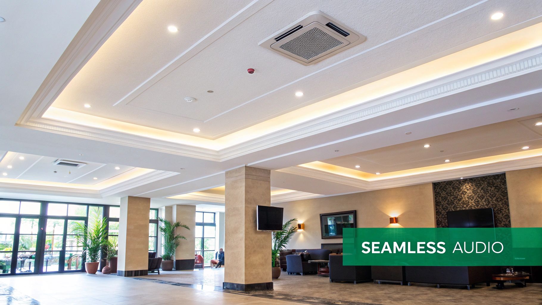 A modern lobby with sophisticated ceiling lighting, an air conditioning unit, and comfortable seating areas.