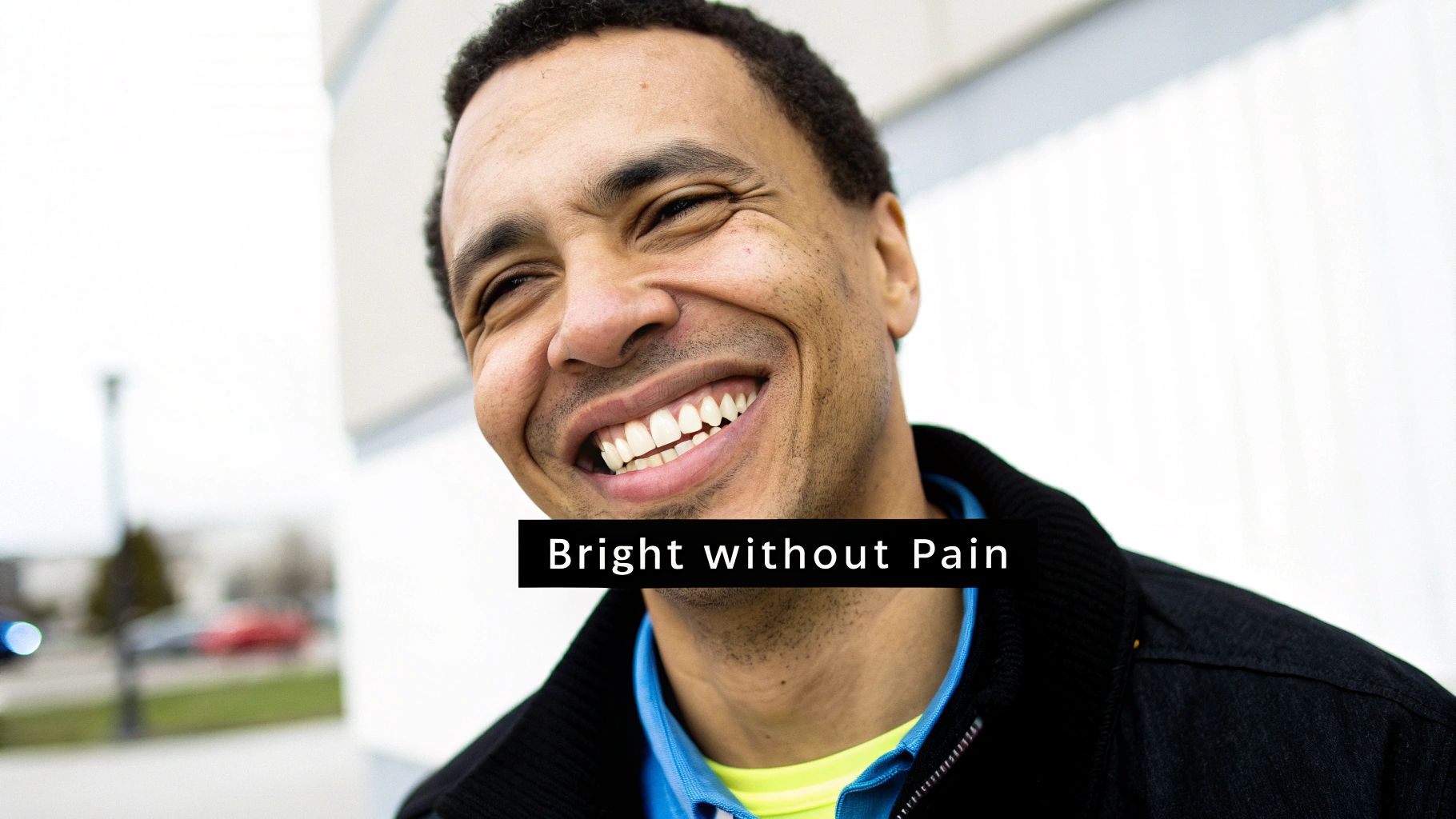 A happy man with a genuine smile, showcasing his bright white teeth and healthy appearance.