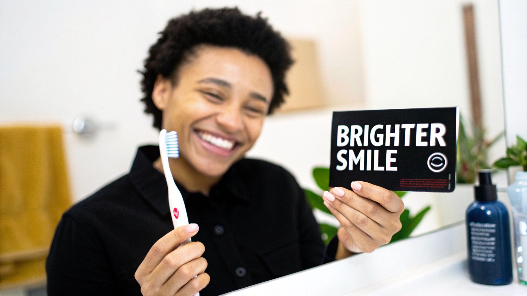 Smiling person holding a toothbrush and a 'Brighter Smile' card, promoting dental care products.