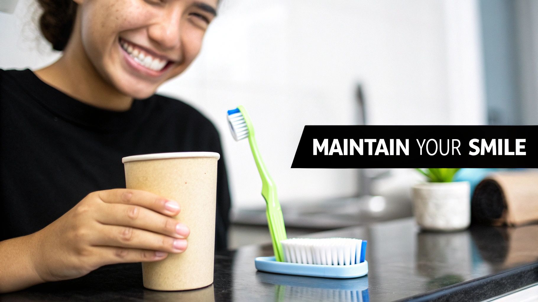 A young person smiling brightly, holding a cup, with toothbrushes on a counter and text 'MAINTAIN YOUR SMILE'.
