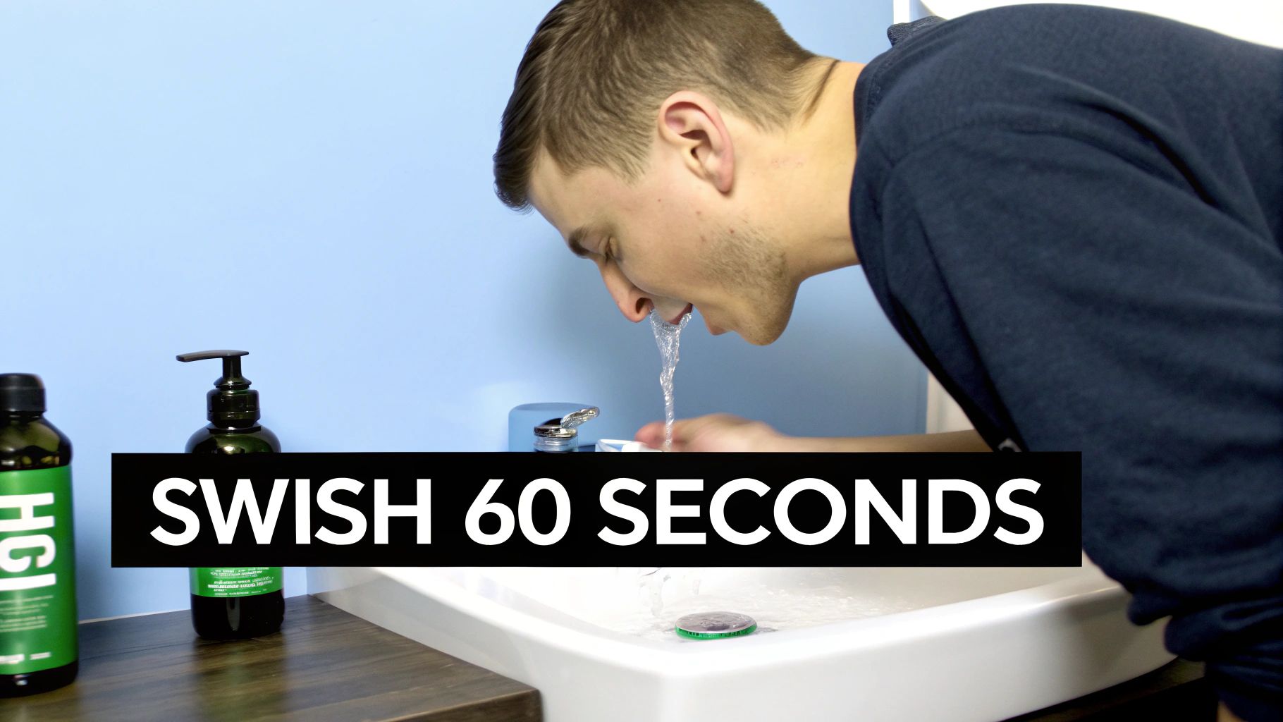 A man swishing water over a sink, with two mouthwash bottles on a shelf nearby.