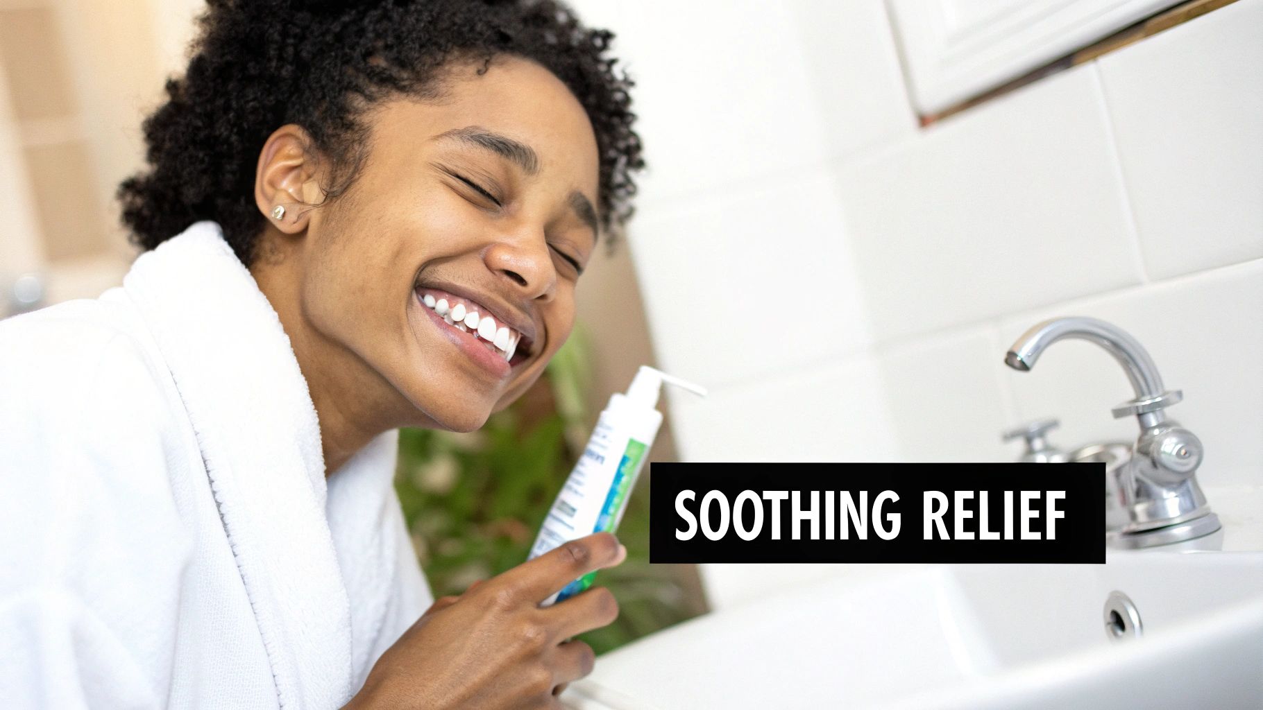 A happy woman in a white robe smiles while holding a product bottle in a clean bathroom with 'SOOTHING RELIEF' text.