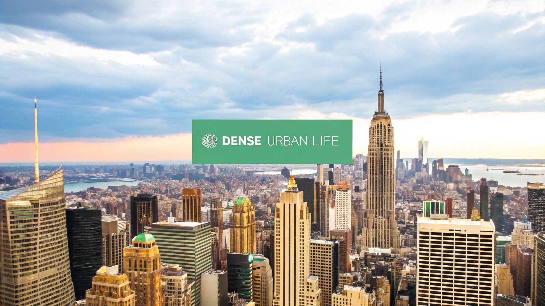 An aerial view of a densely populated city with skyscrapers and tightly packed buildings under a hazy sky.
