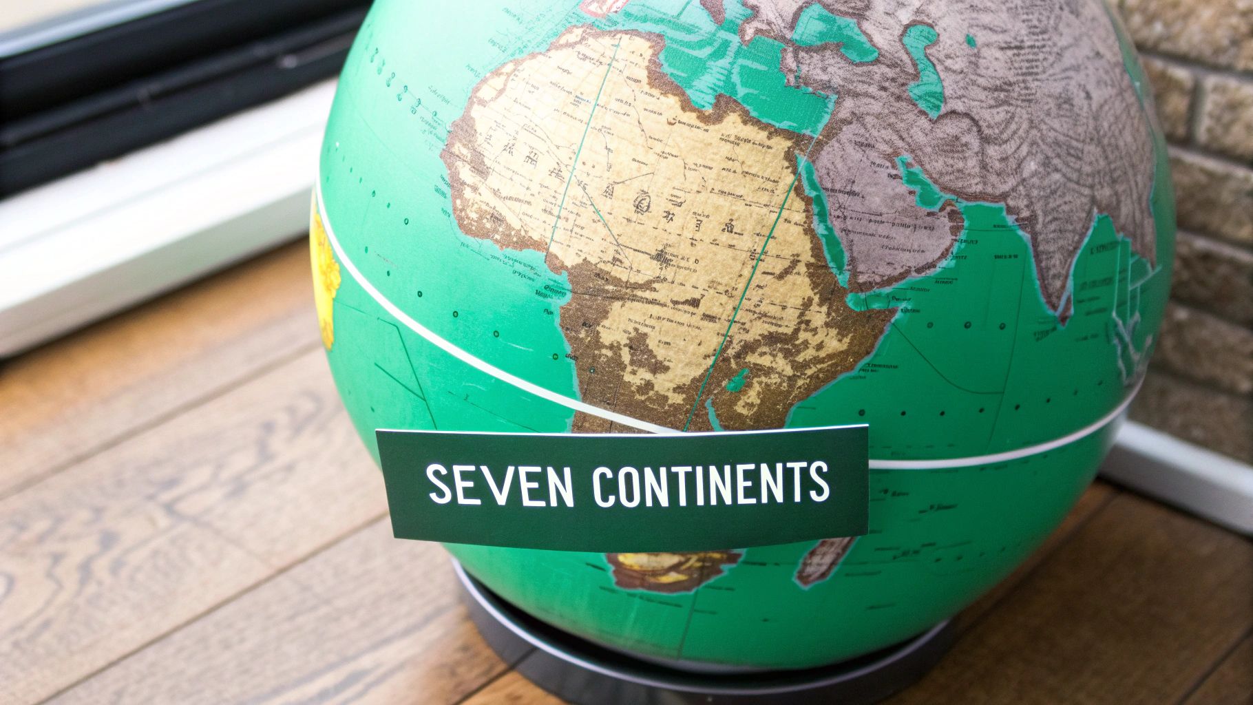 A vibrant, stylized world map highlighting the distinct shapes and colors of the seven continents.