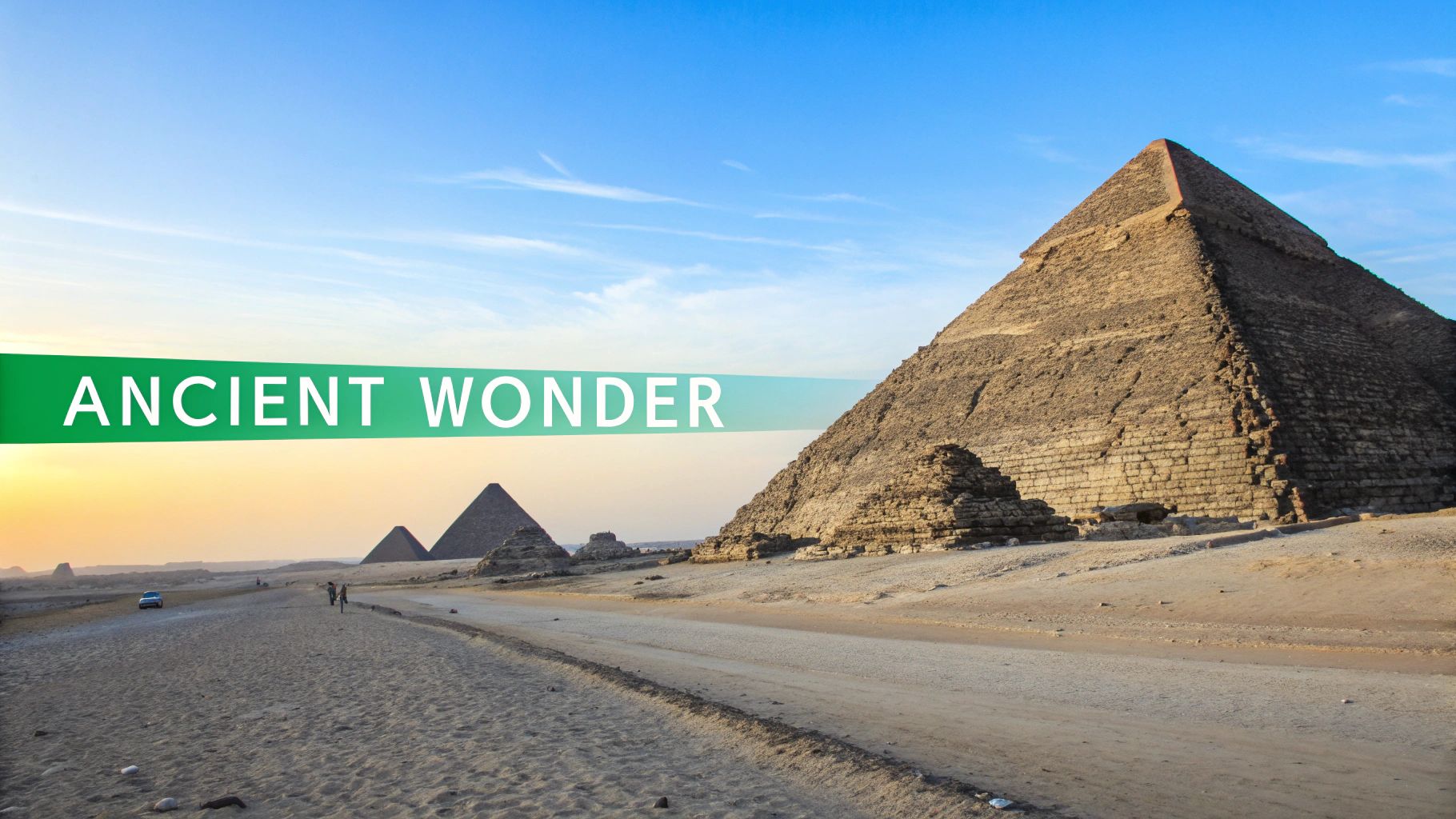 View of the ancient Pyramids of Giza under a blue sky, with desert roads and people.