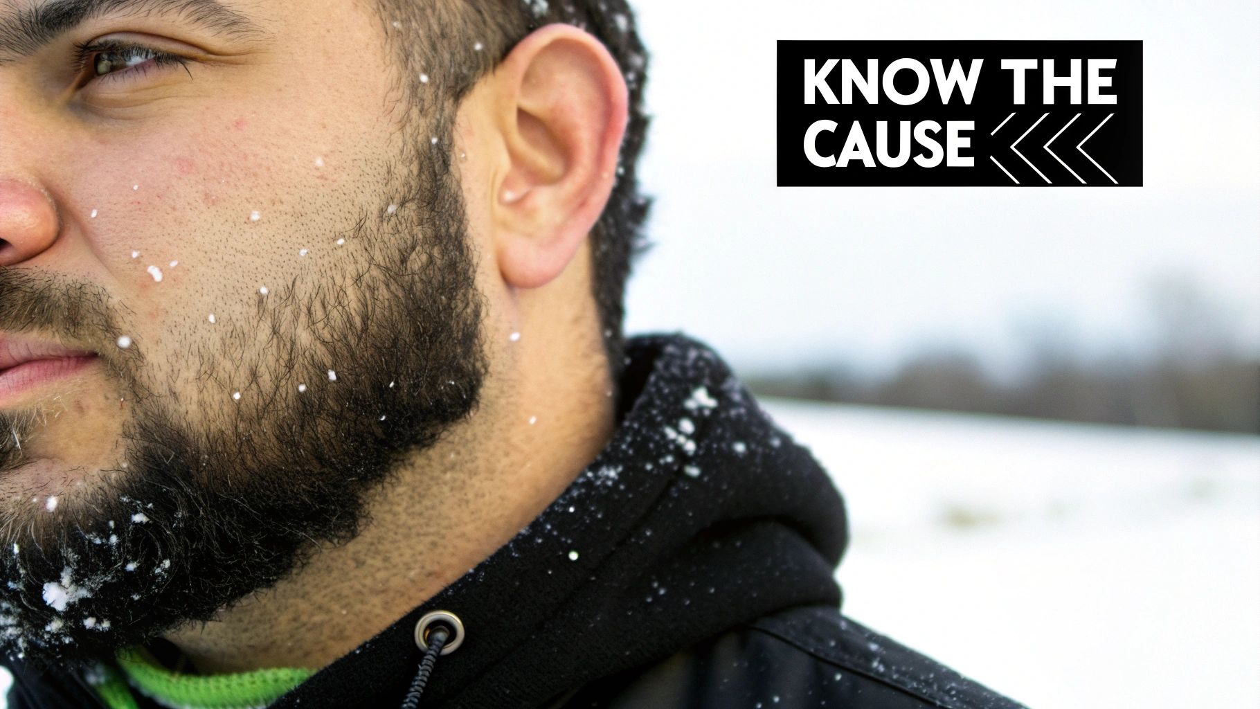 A man with a well-groomed beard looking thoughtfully at his reflection, symbolizing the process of understanding the root causes of beard flakes.