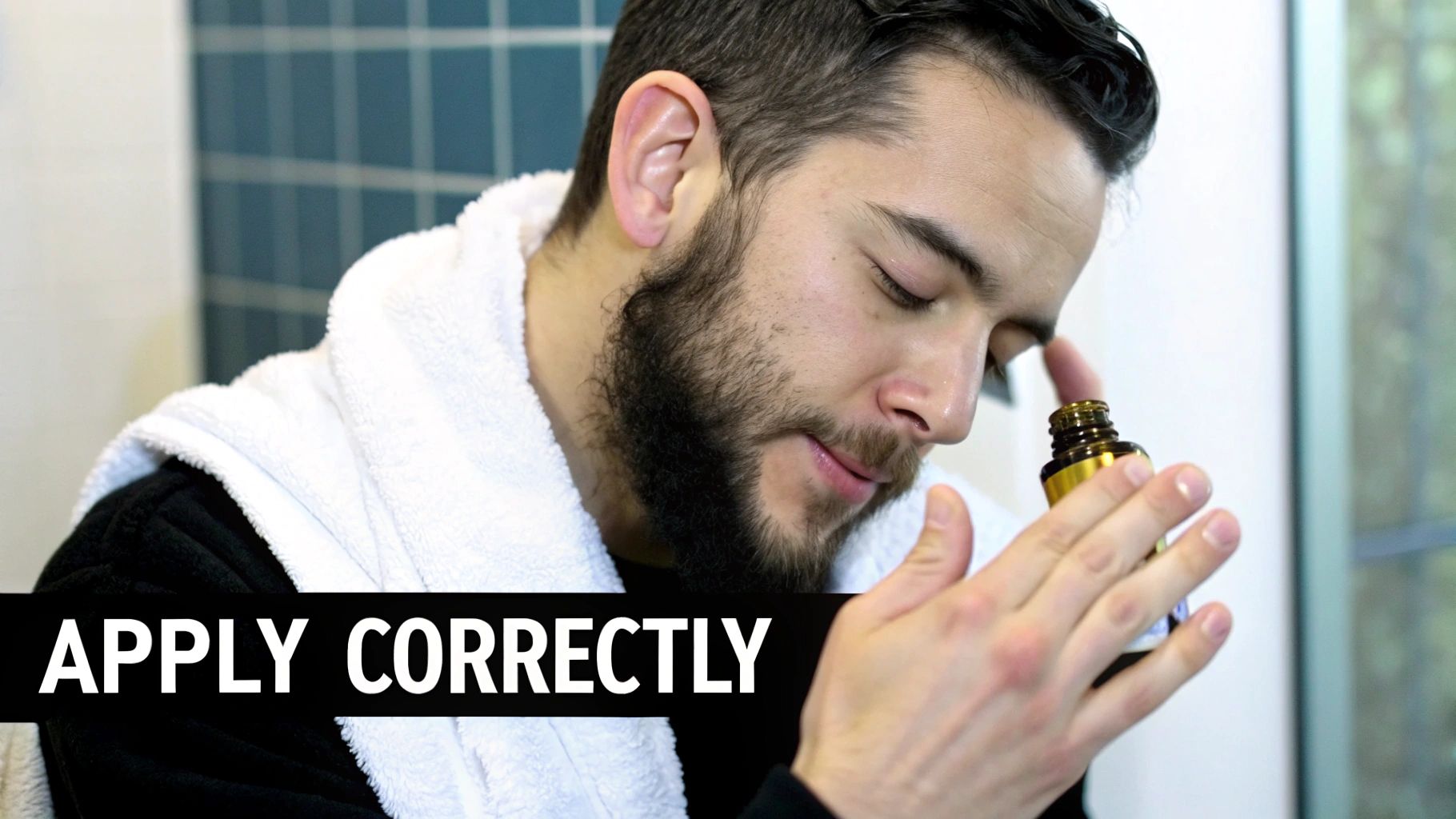 A man with a well-groomed beard applying beard oil.