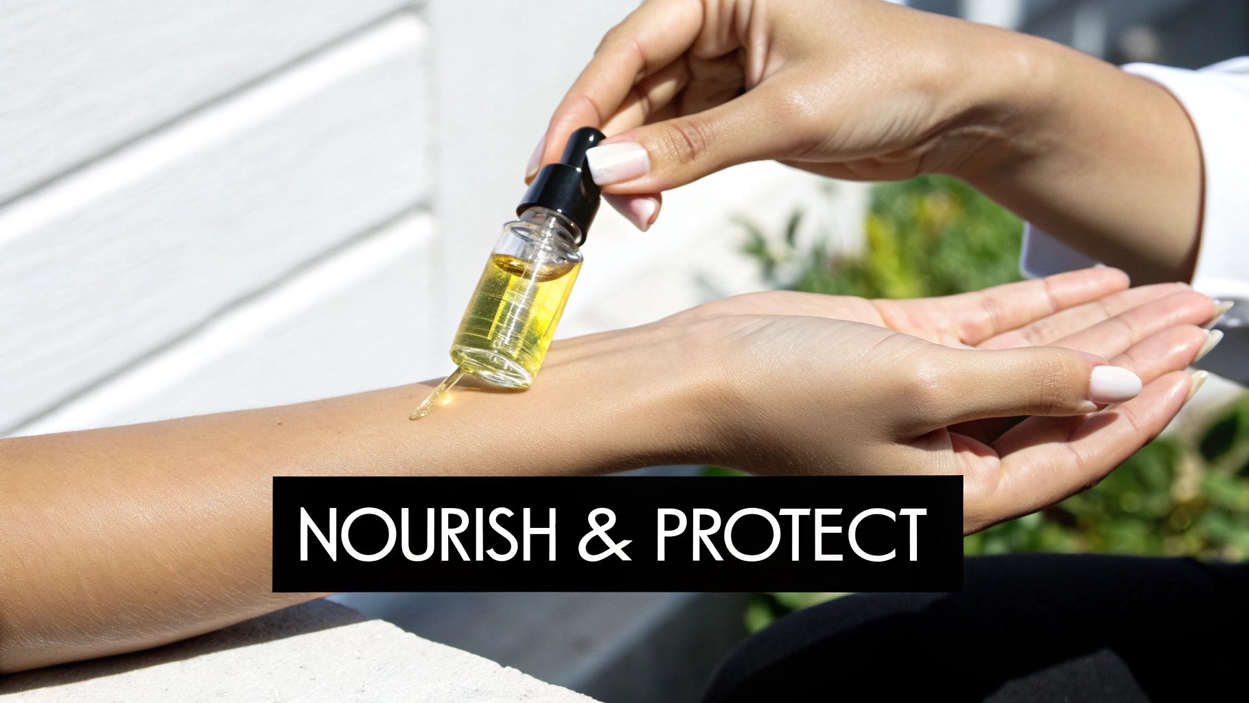 Woman applying yellow body oil from dropper bottle onto arm for skin nourishment and protection