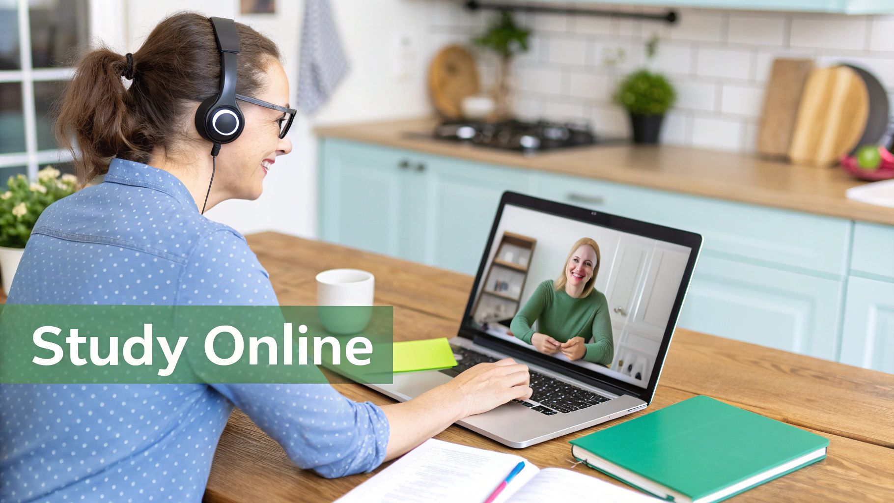 Smiling woman with headphones studies online on a laptop, engaged in a video call.