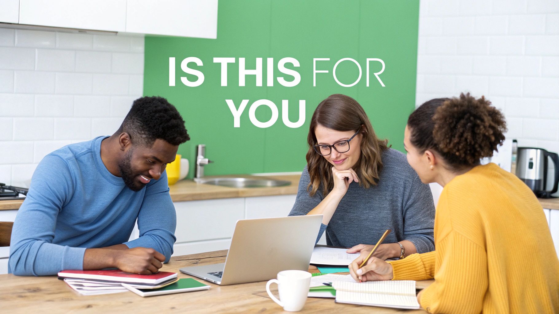 Diverse group of students working together on a laptop and taking notes in a bright kitchen.