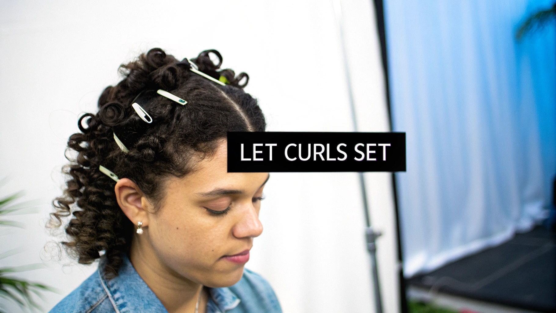 A woman with perfectly finished, glossy blonde curls.