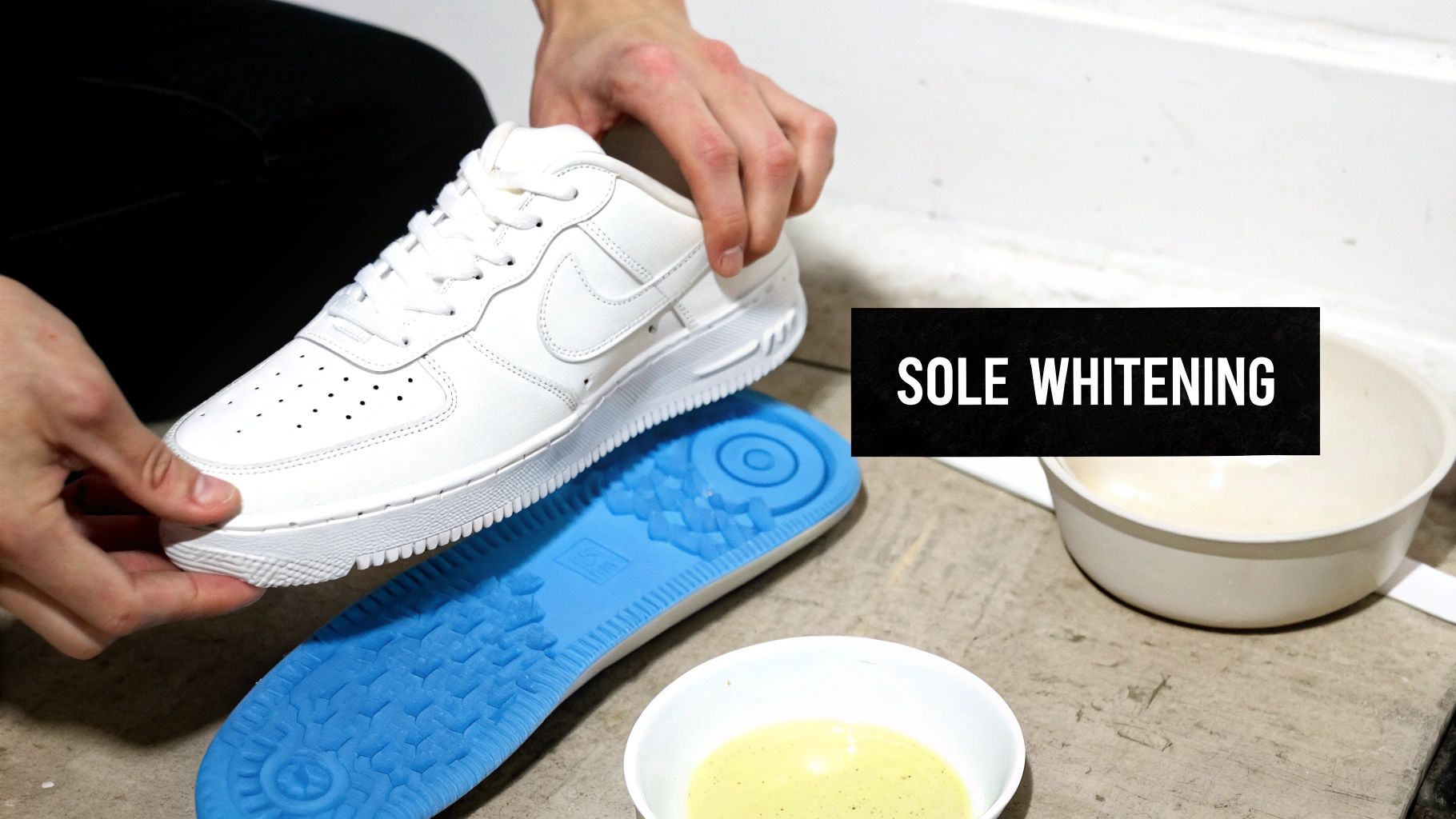 Person holding a white Nike Air Force 1 shoe, preparing it for sole whitening treatment.