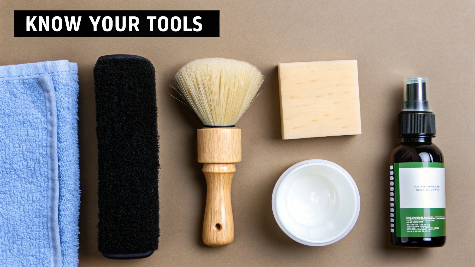 A flat lay of various cleaning tools including a blue towel, brushes, sponge, bowl, and spray bottle.