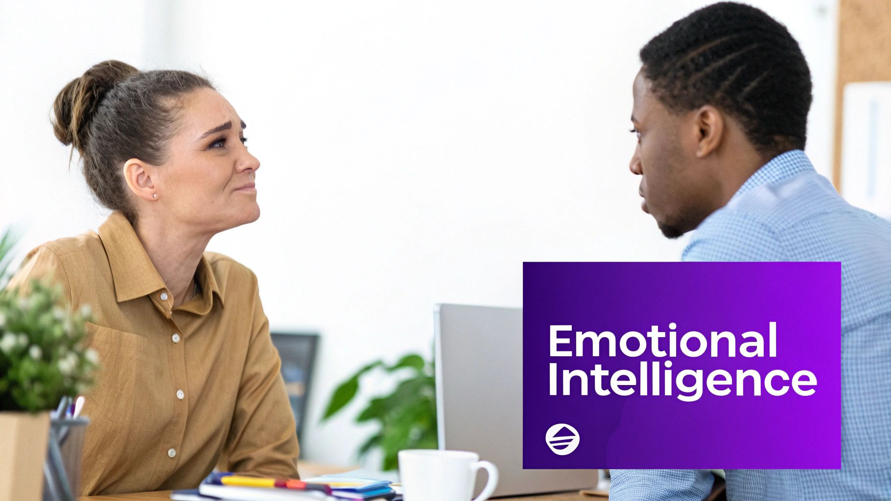 Two professionals having a workplace conversation about emotional intelligence and leadership development