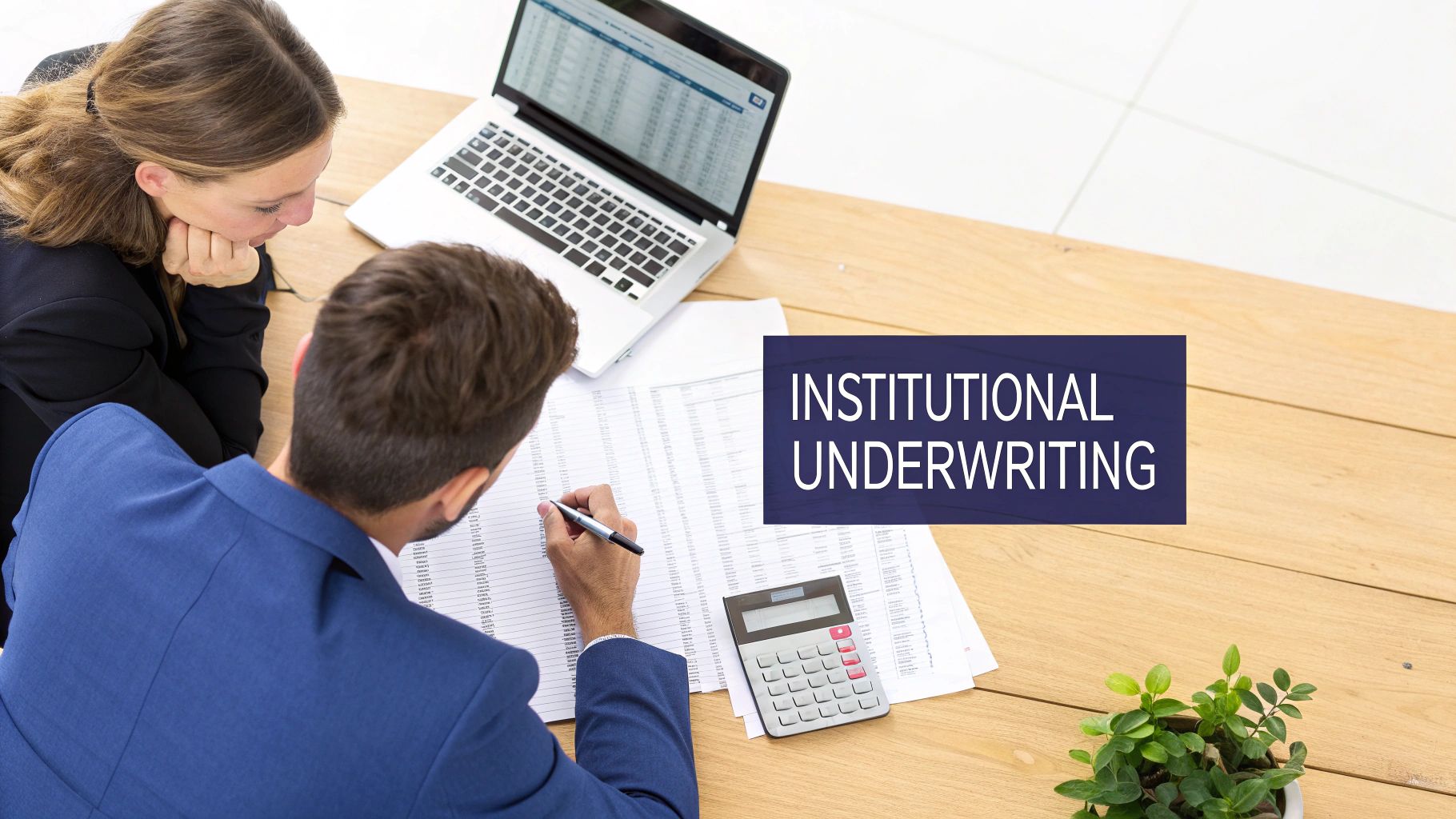 Two business professionals reviewing financial documents and data for institutional underwriting at a desk.