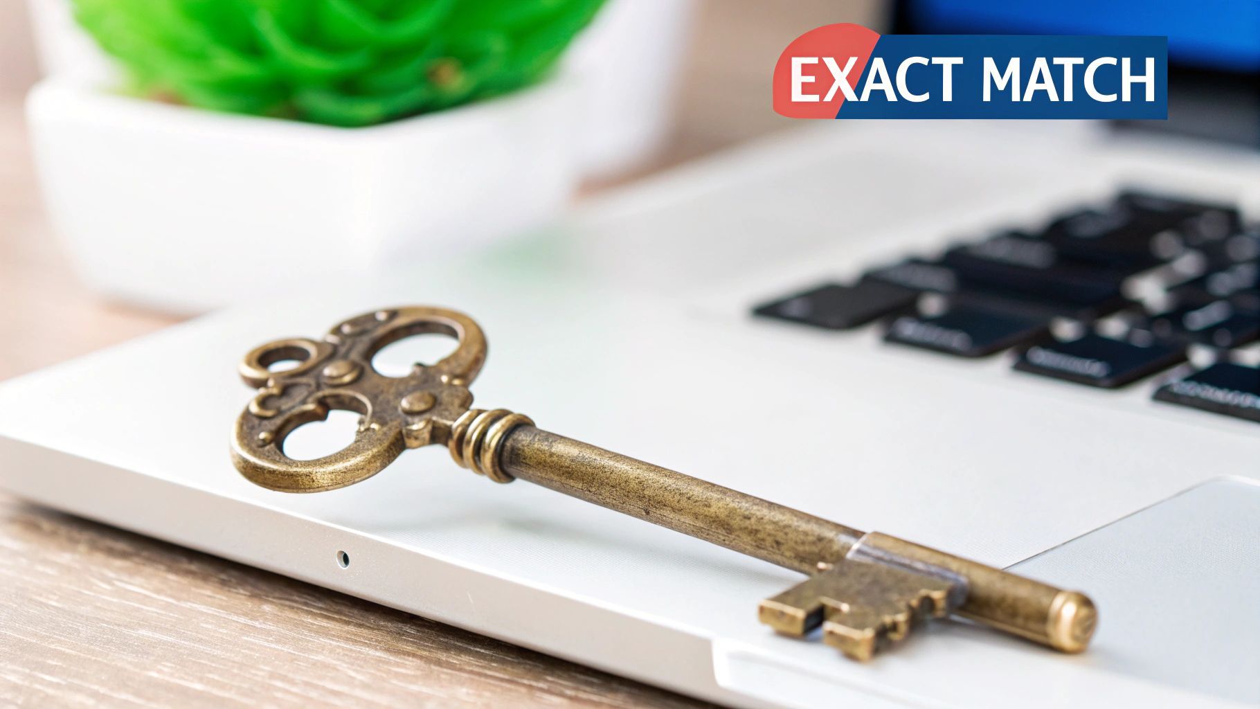 An antique brass key rests on a silver laptop, with a green plant and 'EXACT MATCH' graphic.