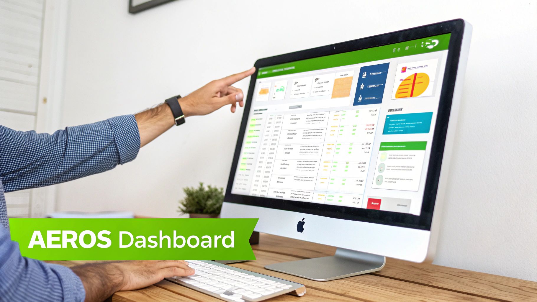 Person pointing at a computer screen displaying the 'AEROS Dashboard' with various charts and data.