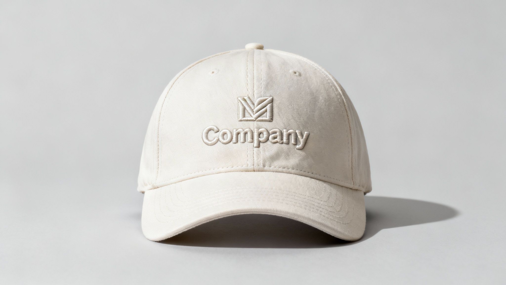 A close-up of a high-quality embroidered logo on a black cap, showcasing the texture of the stitching.