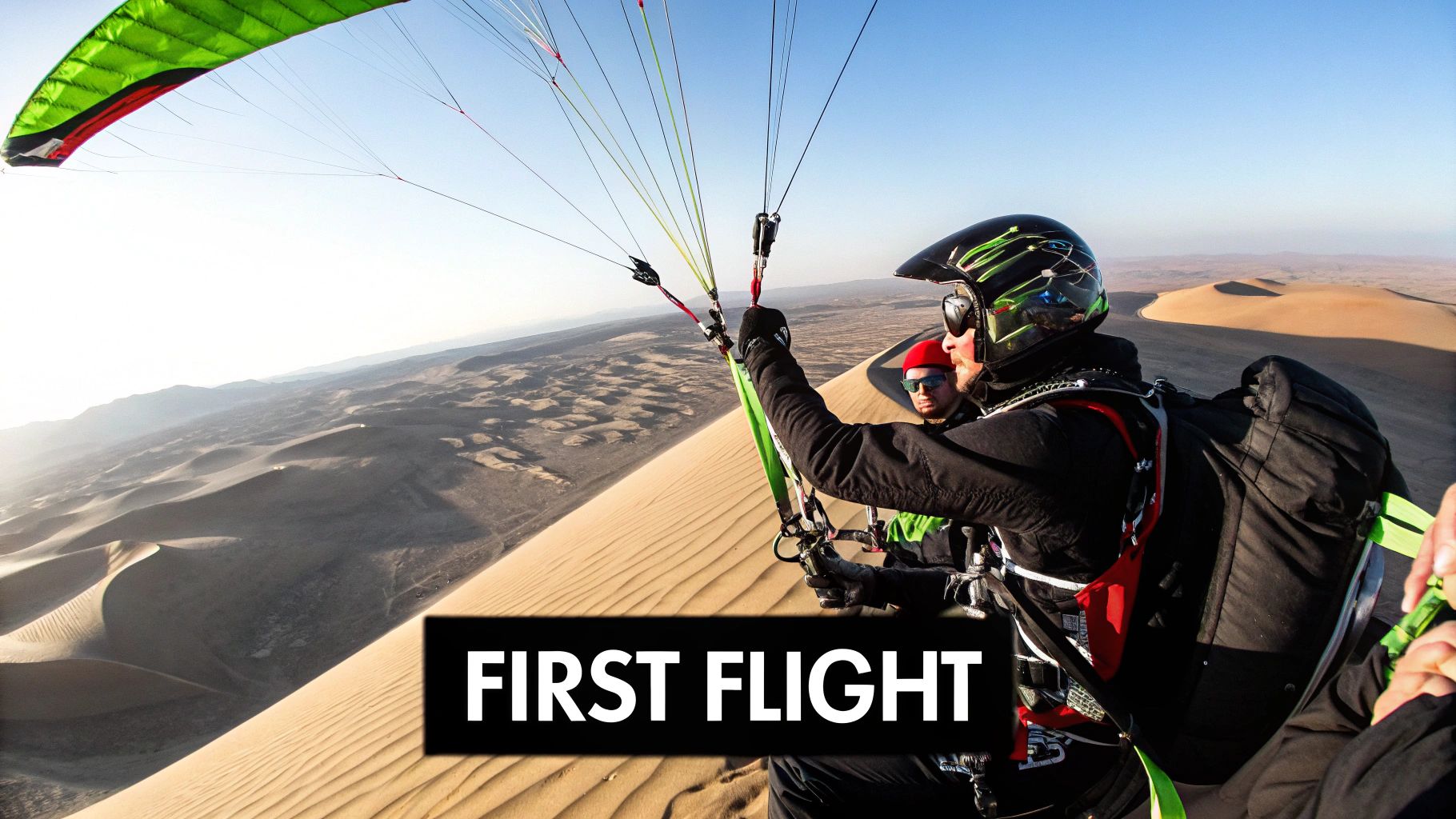 A paraglider soaring over the expansive desert landscape near Dubai