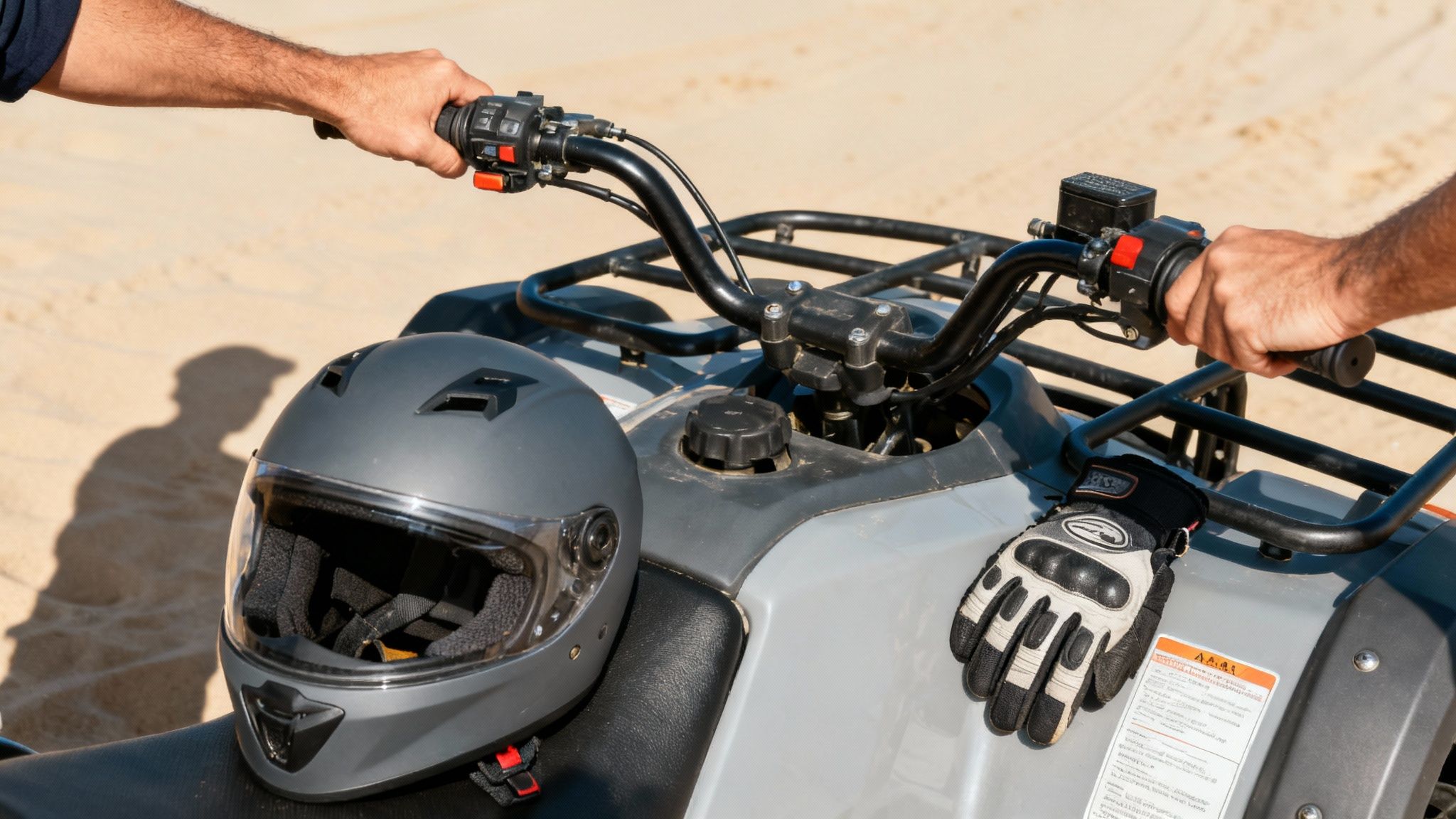 A person wearing a helmet and gear safely riding a quad bike across desert dunes.
