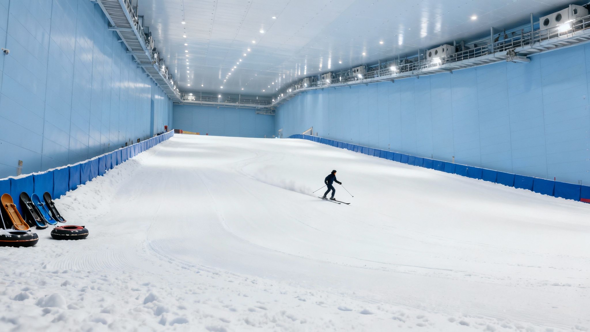 Indoor ski slope with artificial snow and skier at Dubai indoor winter sports facility