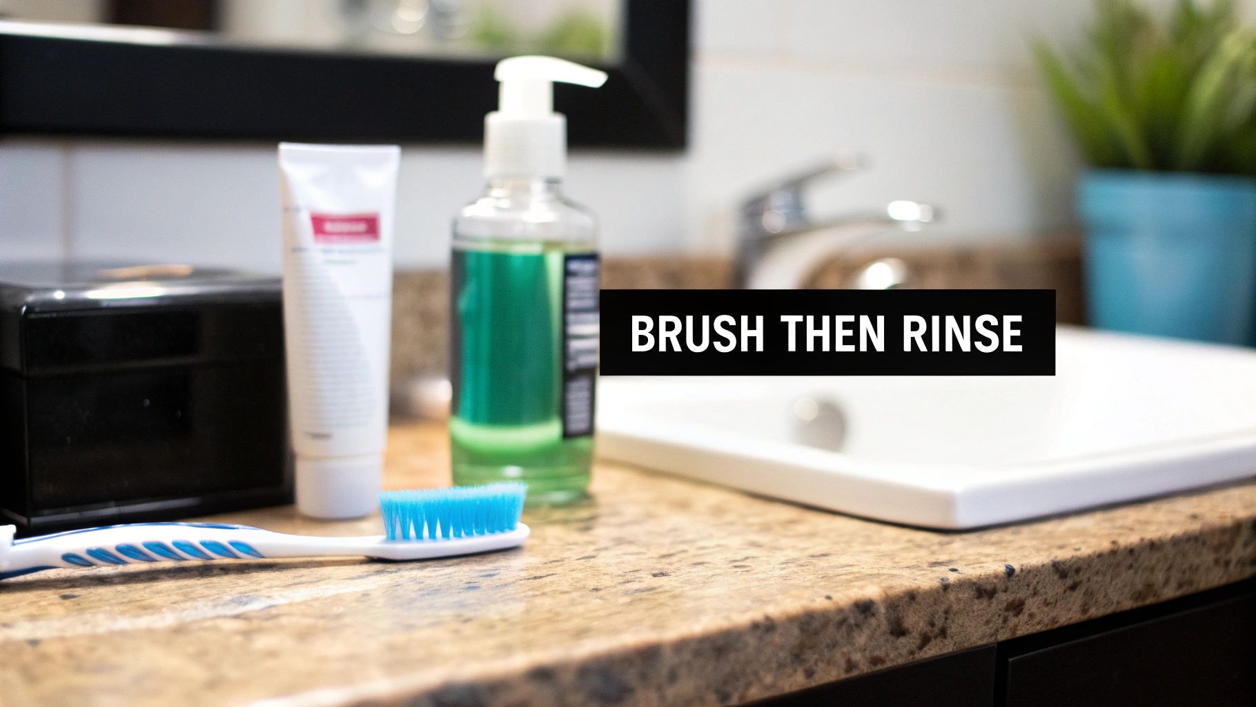 A toothbrush, toothpaste, and green liquid soap/mouthwash bottle on a speckled bathroom counter with a sink.