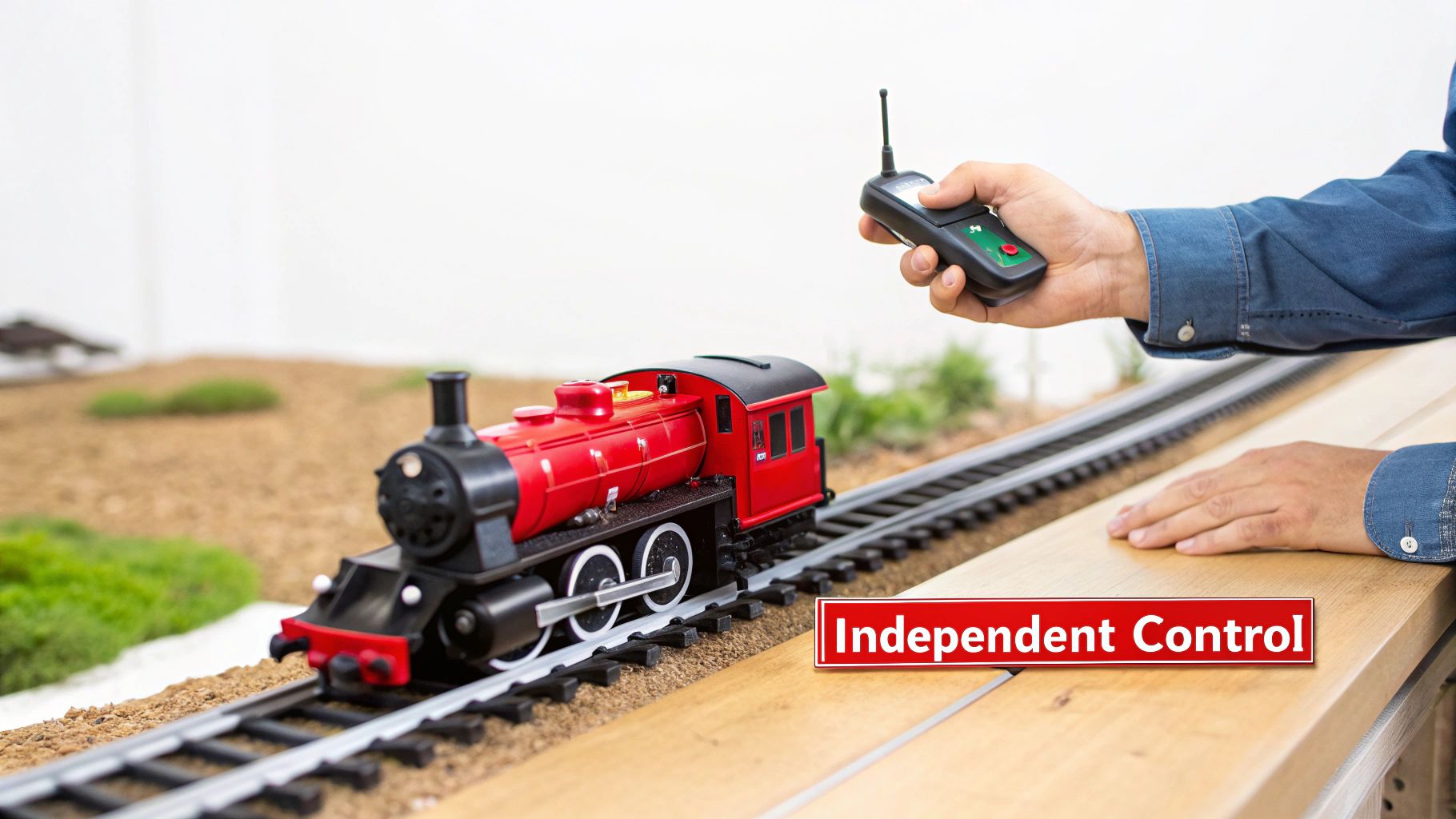 A person operating a model train layout with a digital command control system.