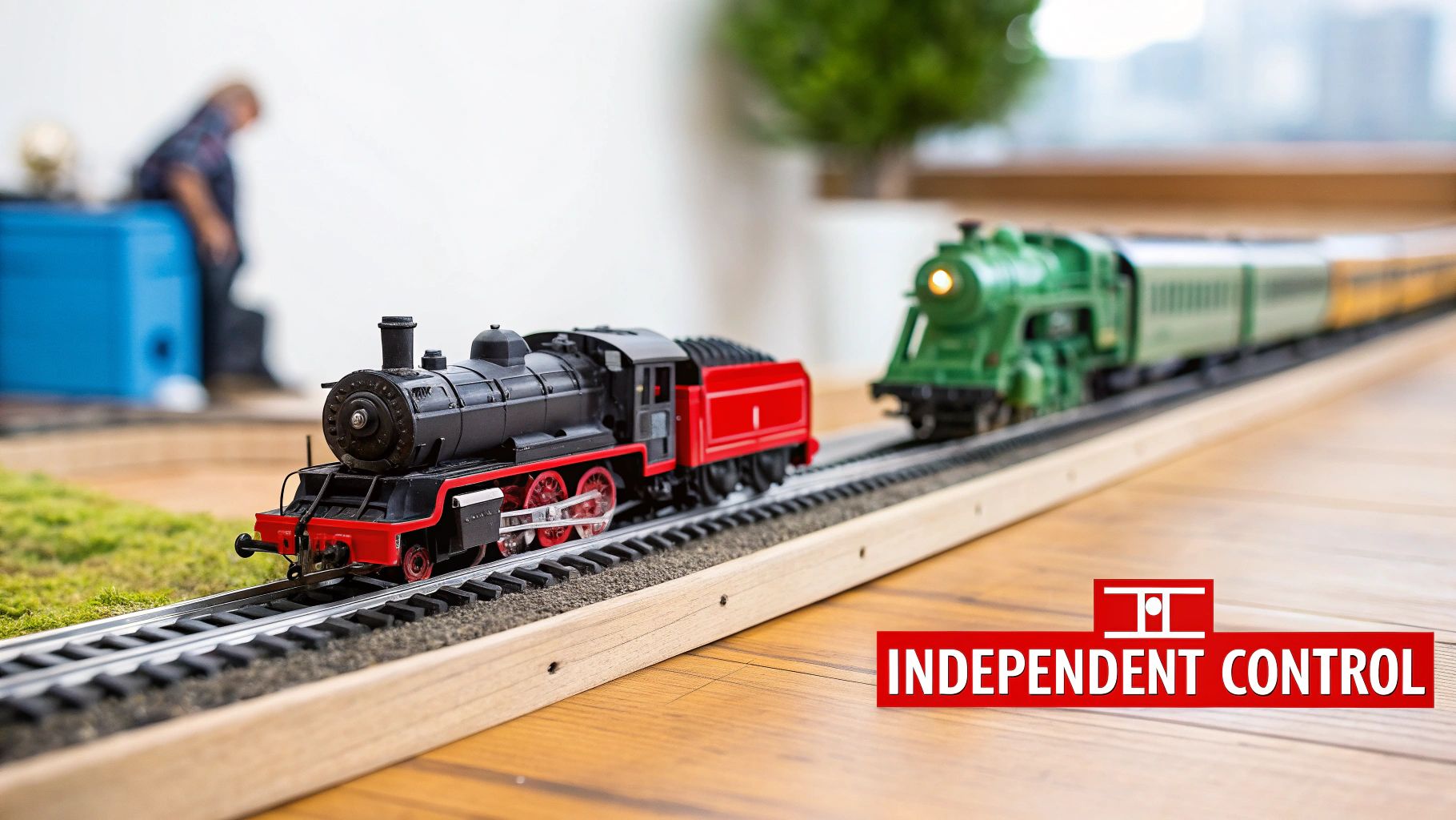 Two model trains, a black and red steam locomotive and a green passenger train, on tracks with text 'Independent Control'.
