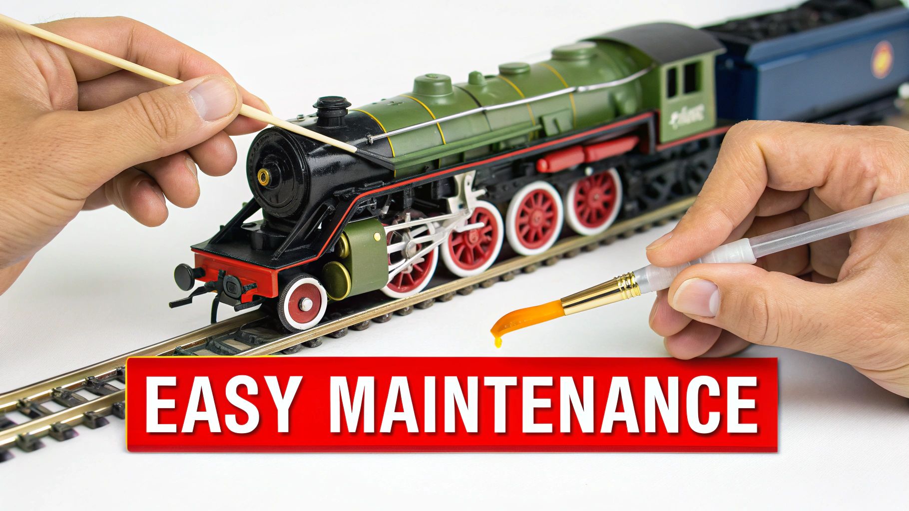 A person's hand carefully cleaning the wheels of an N scale locomotive with a small tool.