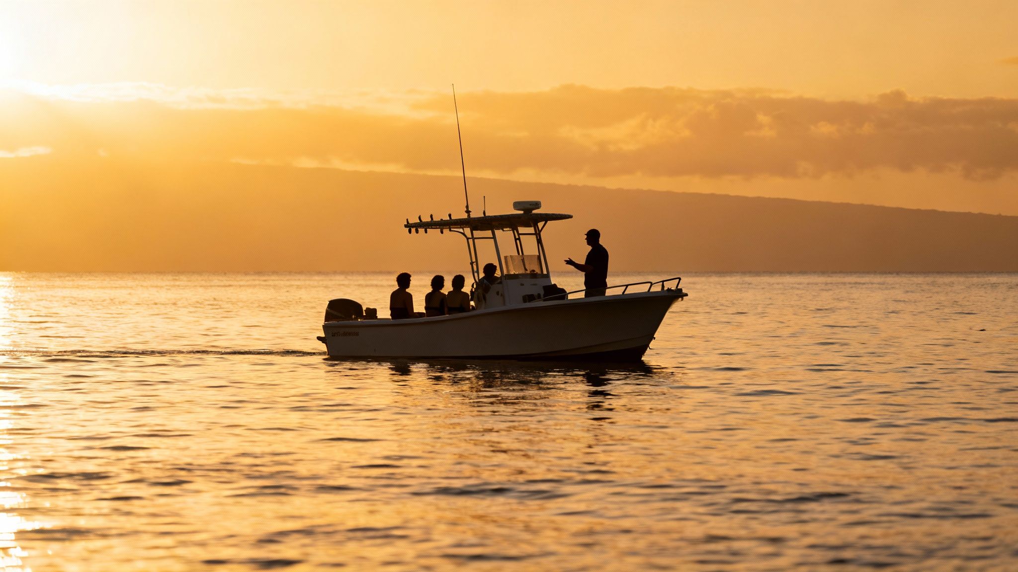 People on a boat with a guide during a beautiful golden sunset on the ocean.