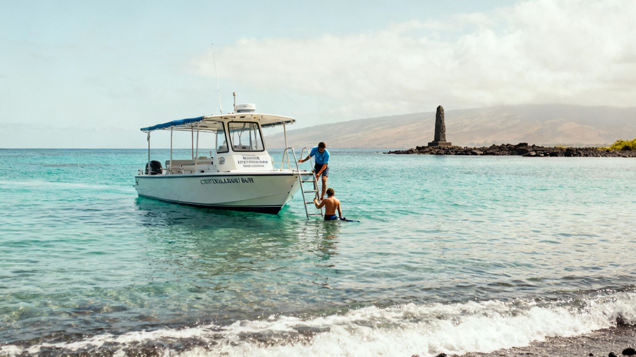 Two men by a snorkeling boat ladder in clear turquoise water at Kealakekua Bay.