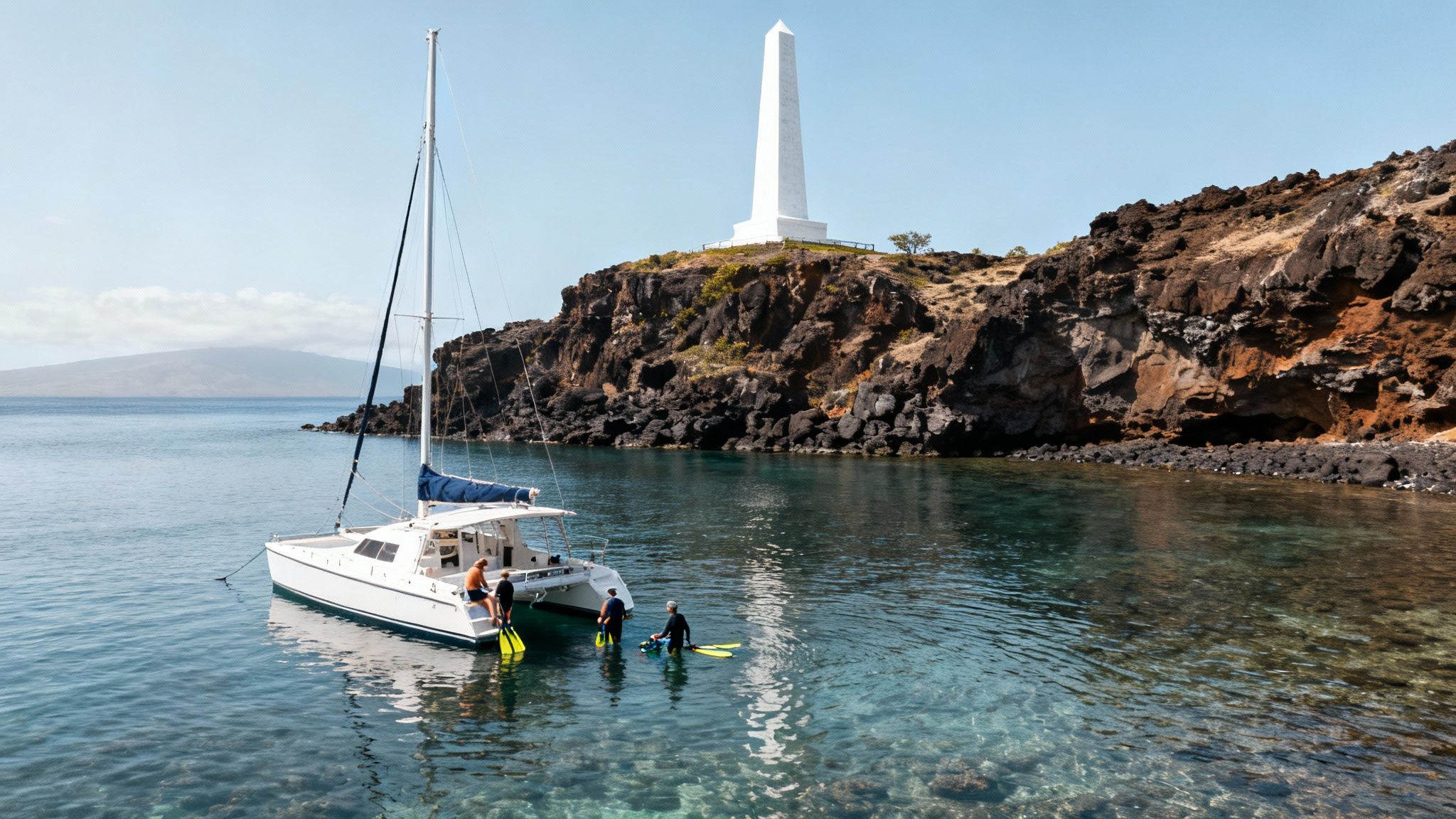 Tour boat anchored in the clear turquoise waters of Kealakekua Bay, with snorkelers in the water.
