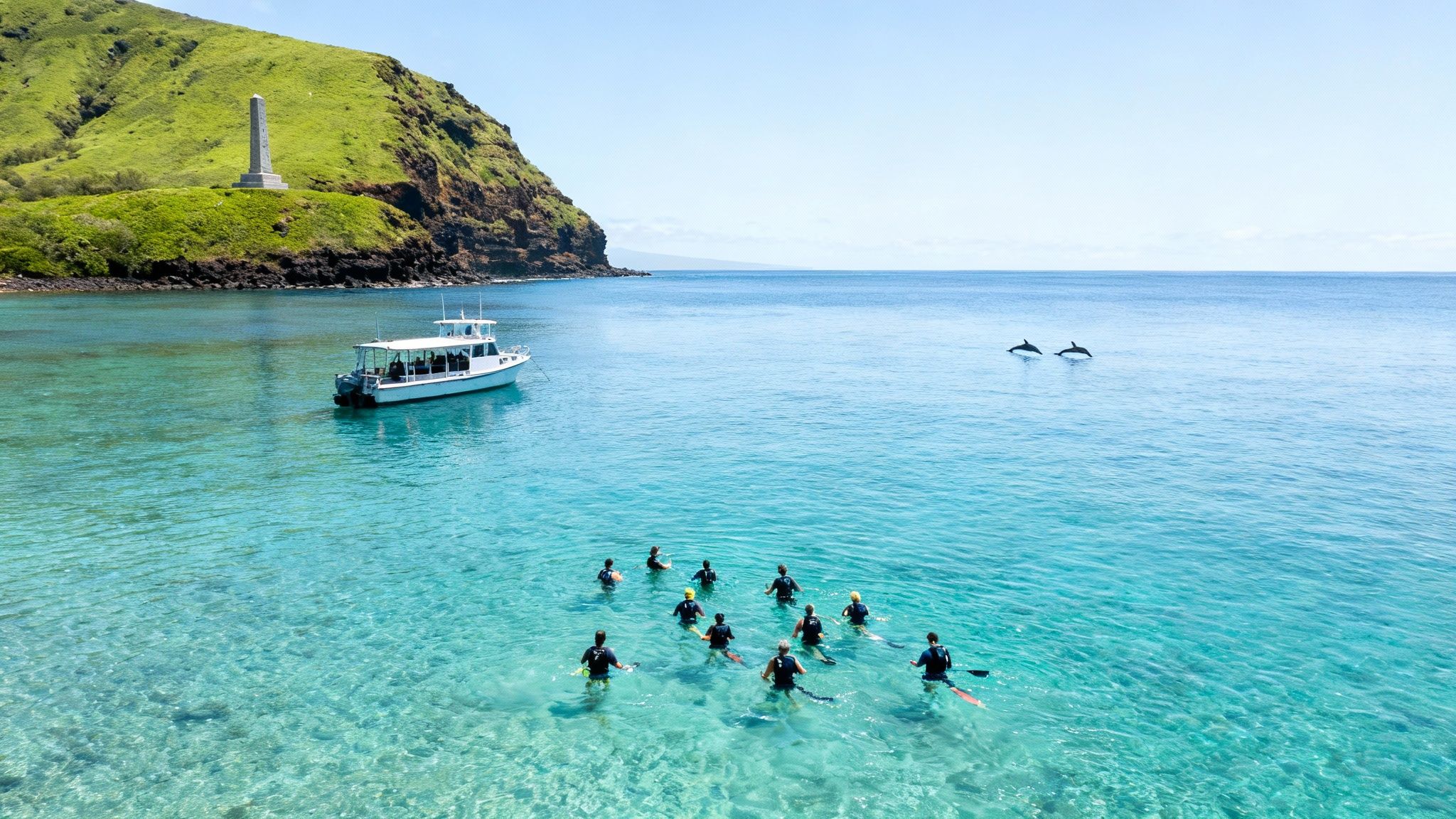 A group snorkeling in clear blue water with a boat nearby, two dolphins, a green hill, and an obelisk.