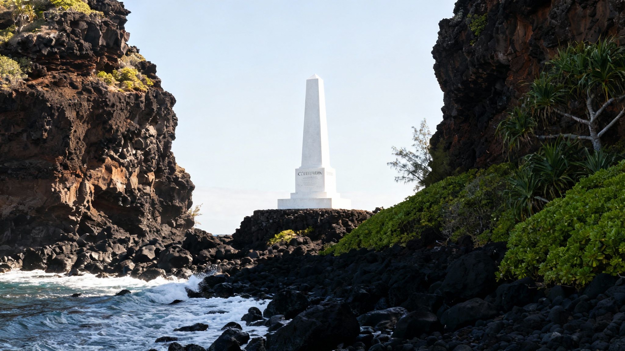 The white Captain Cook Monument stands tall against the dramatic cliffs of Kealakekua Bay, Hawaii.