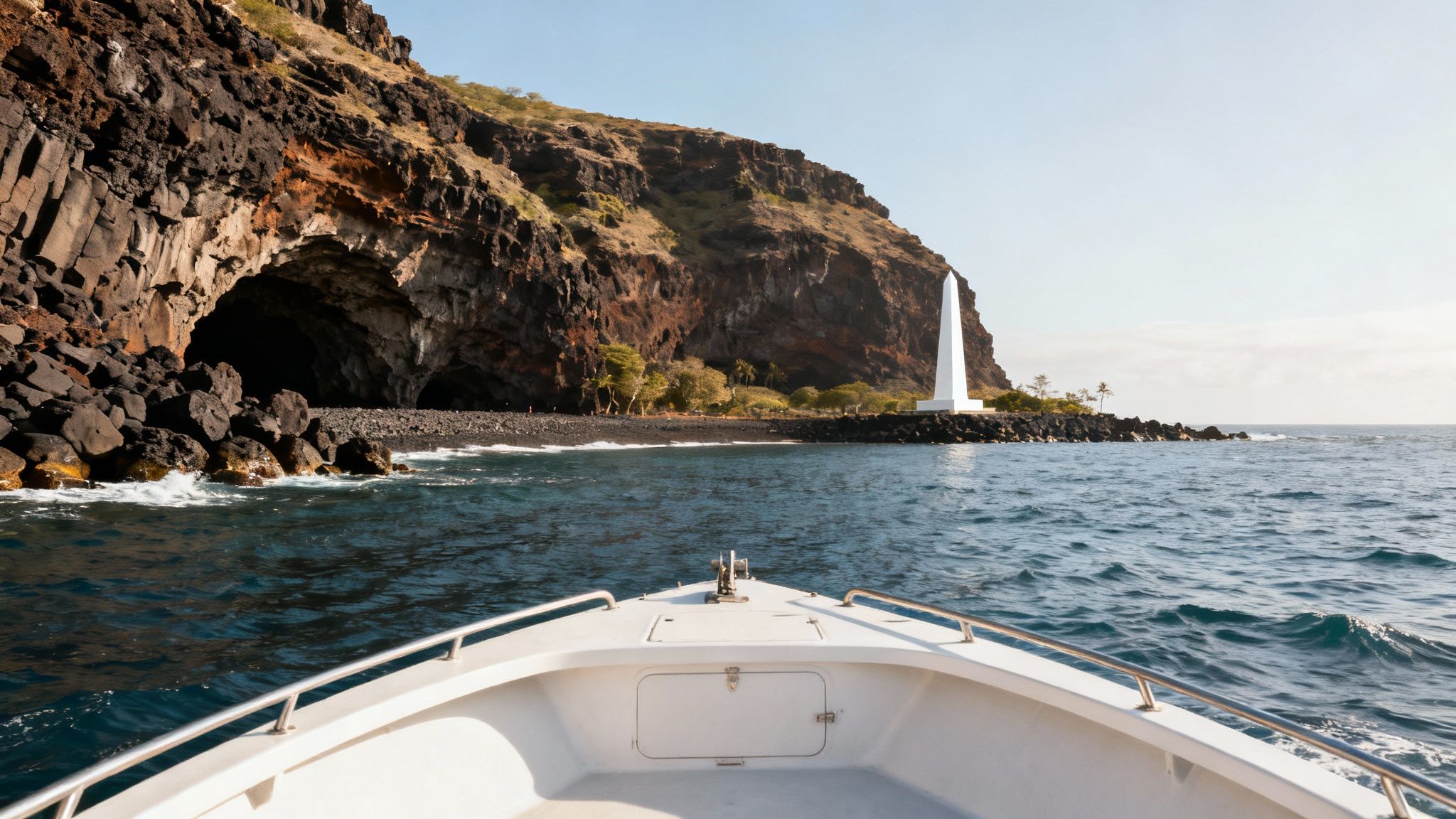 A scenic view of the Kona coast with volcanic cliffs and the Captain Cook Monument in the distance.