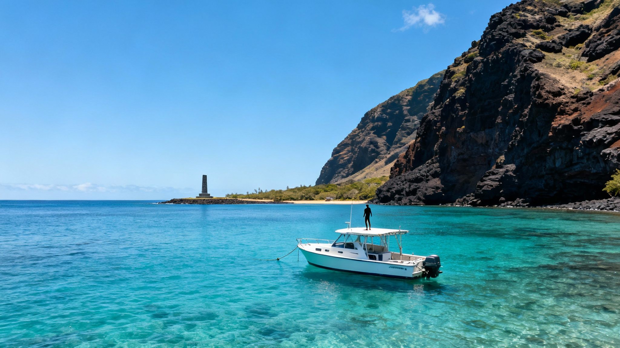 Turquoise boat anchored in crystal clear Hawaiian waters near volcanic cliffs and monument