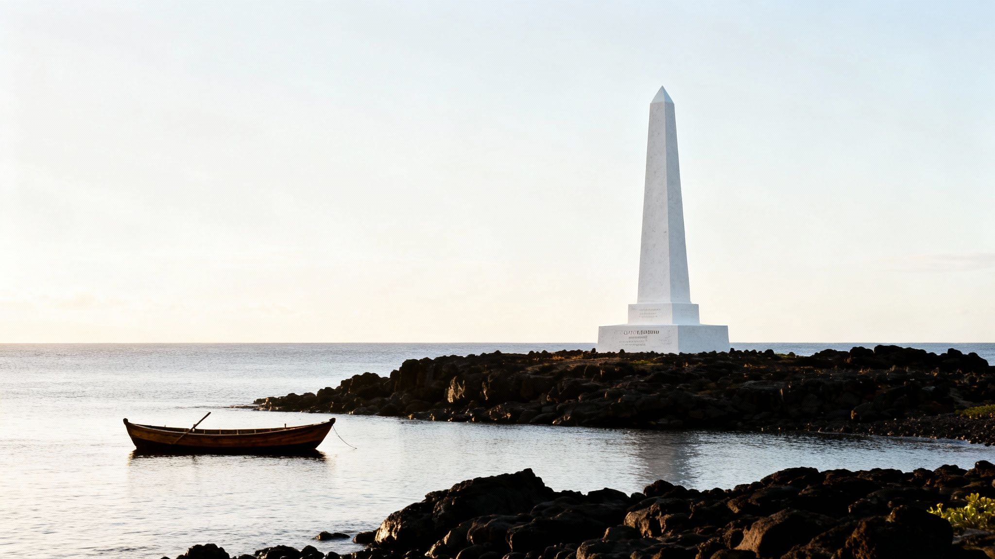 A tall white obelisk monument stands on a rocky coastline overlooking the ocean, with a small wooden boat floating nearby.