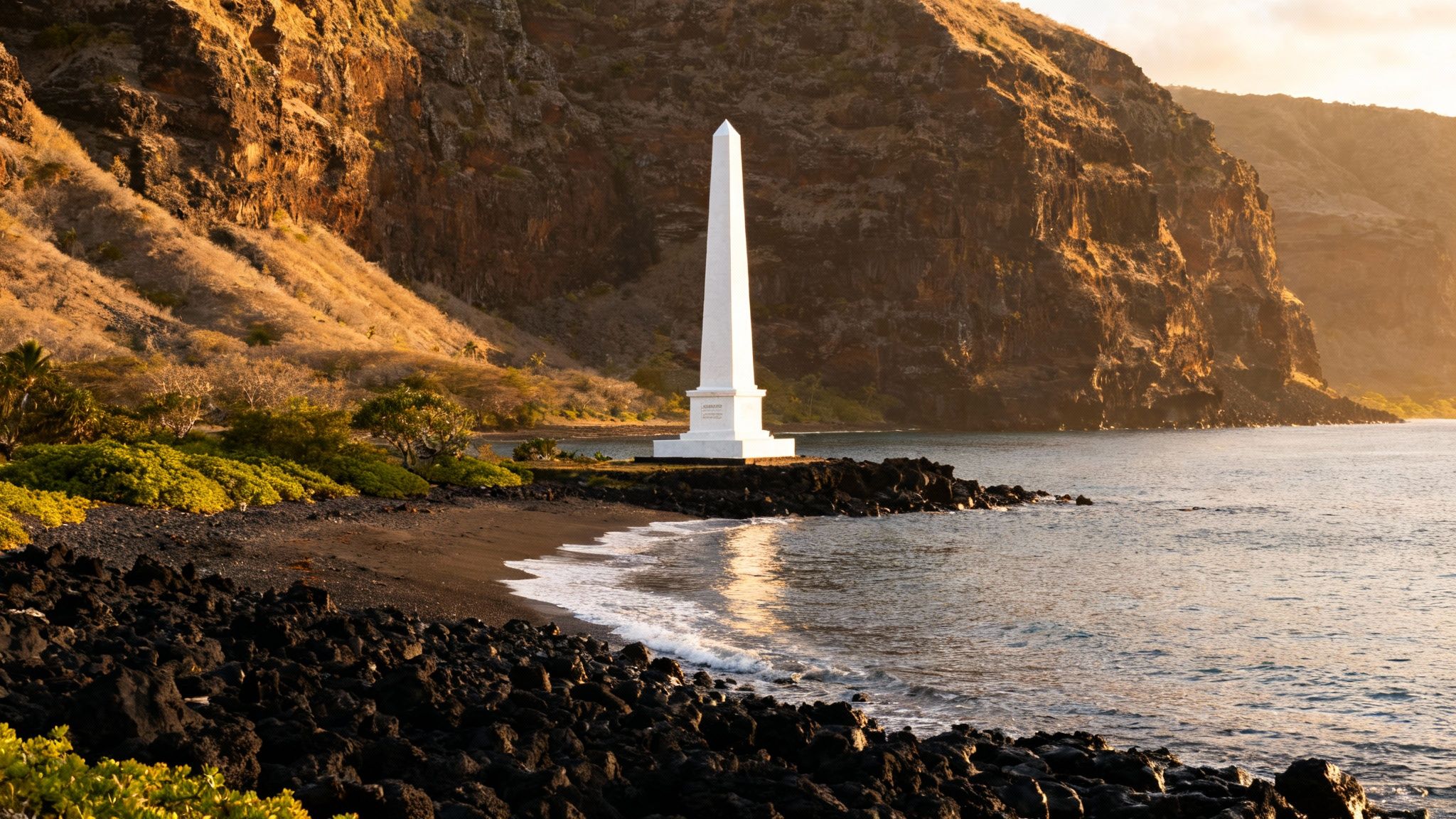 Captain Cook Monument, a white obelisk on a black sand beach by the ocean with cliffs at sunset.