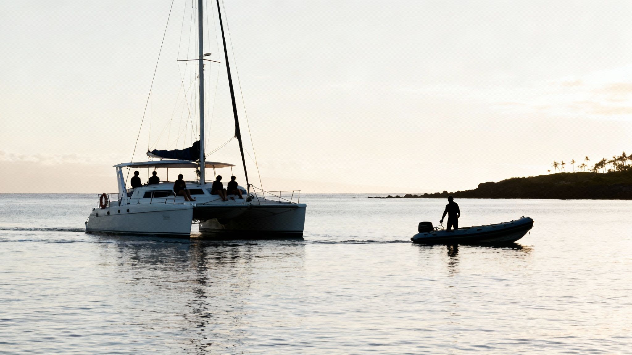 A group of snorkelers preparing their gear on the deck of a spacious catamaran.