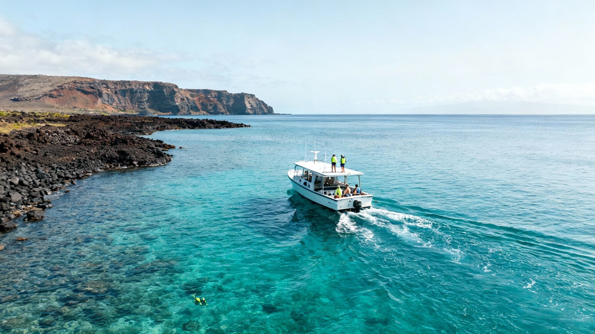 A group of snorkelers exploring the vibrant coral reefs in the clear blue waters of Kealakekua Bay.