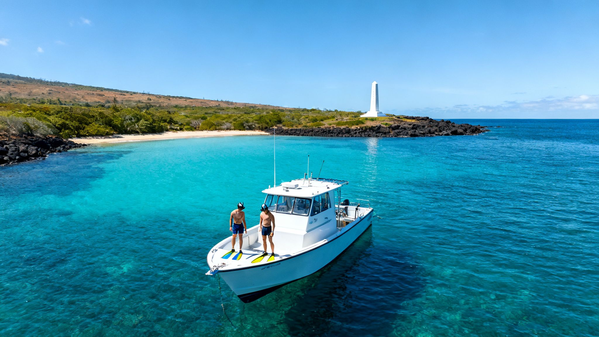 Two men on a white boat in clear turquoise water near a sandy beach and a white monument.