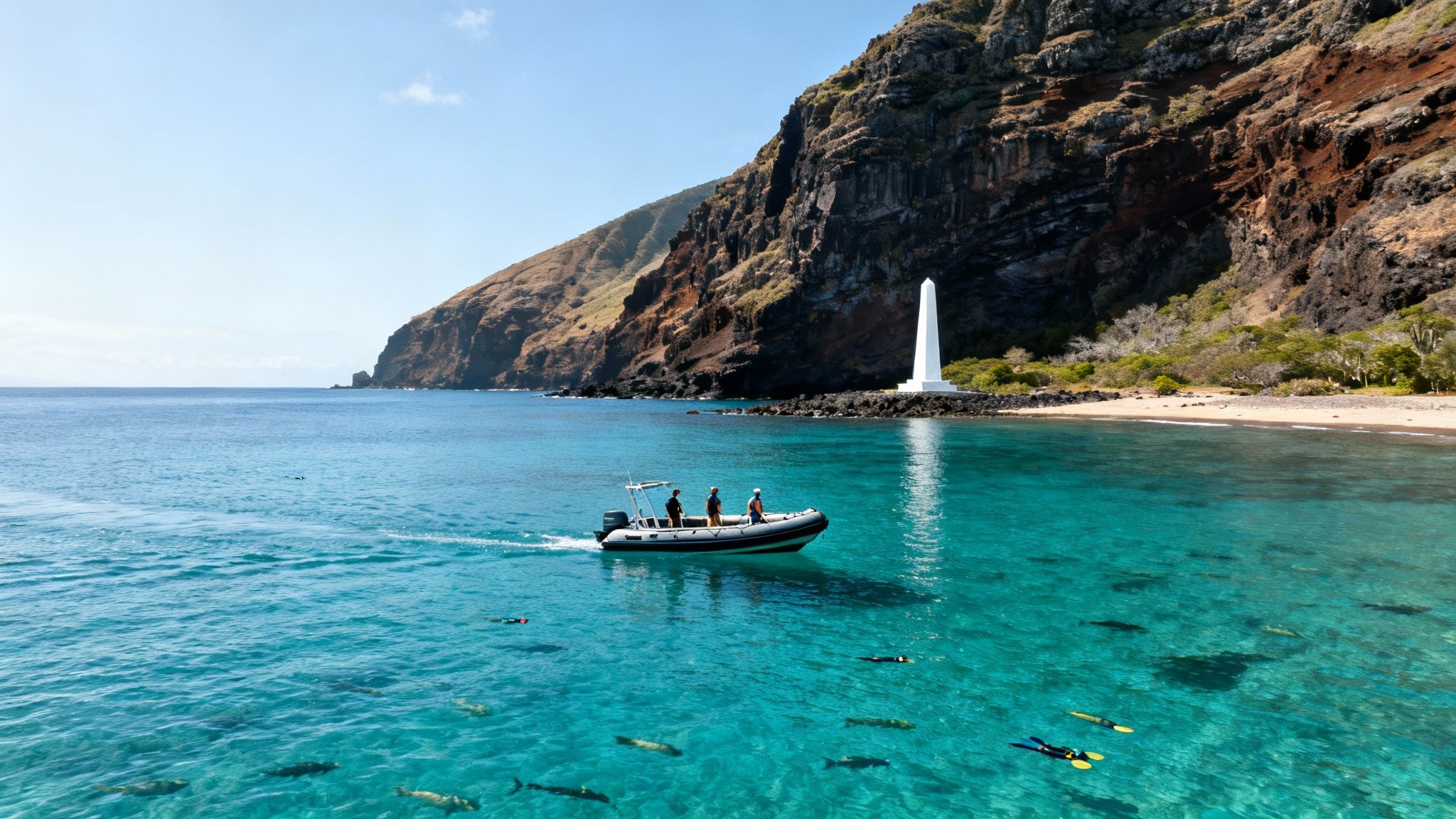 Snorkelers swim near a boat on clear water by a white monument on a rocky Hawaii coast.