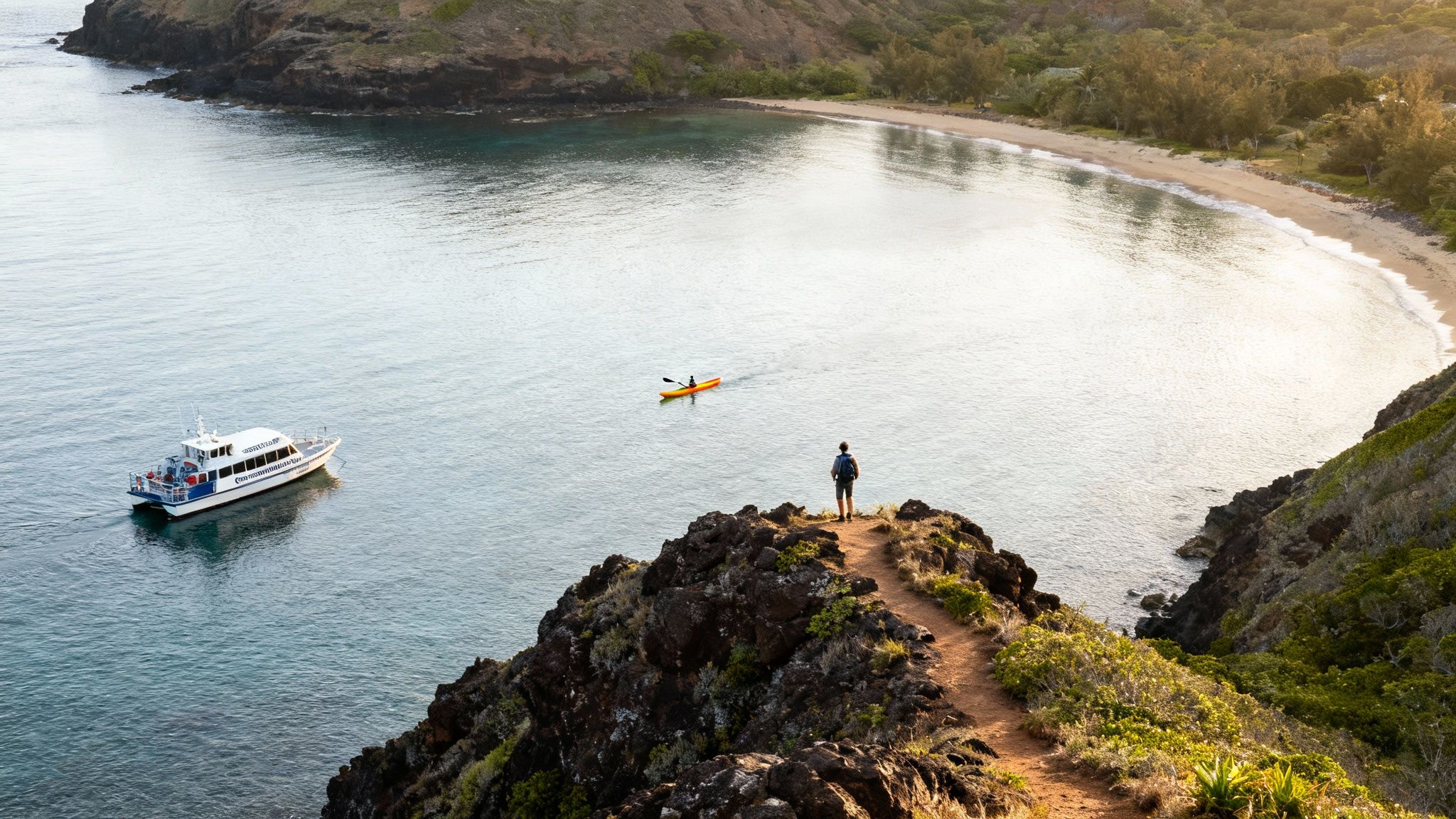 A hiker on a rocky cliff overlooking a serene bay with a boat, kayaker, and a lush shoreline.