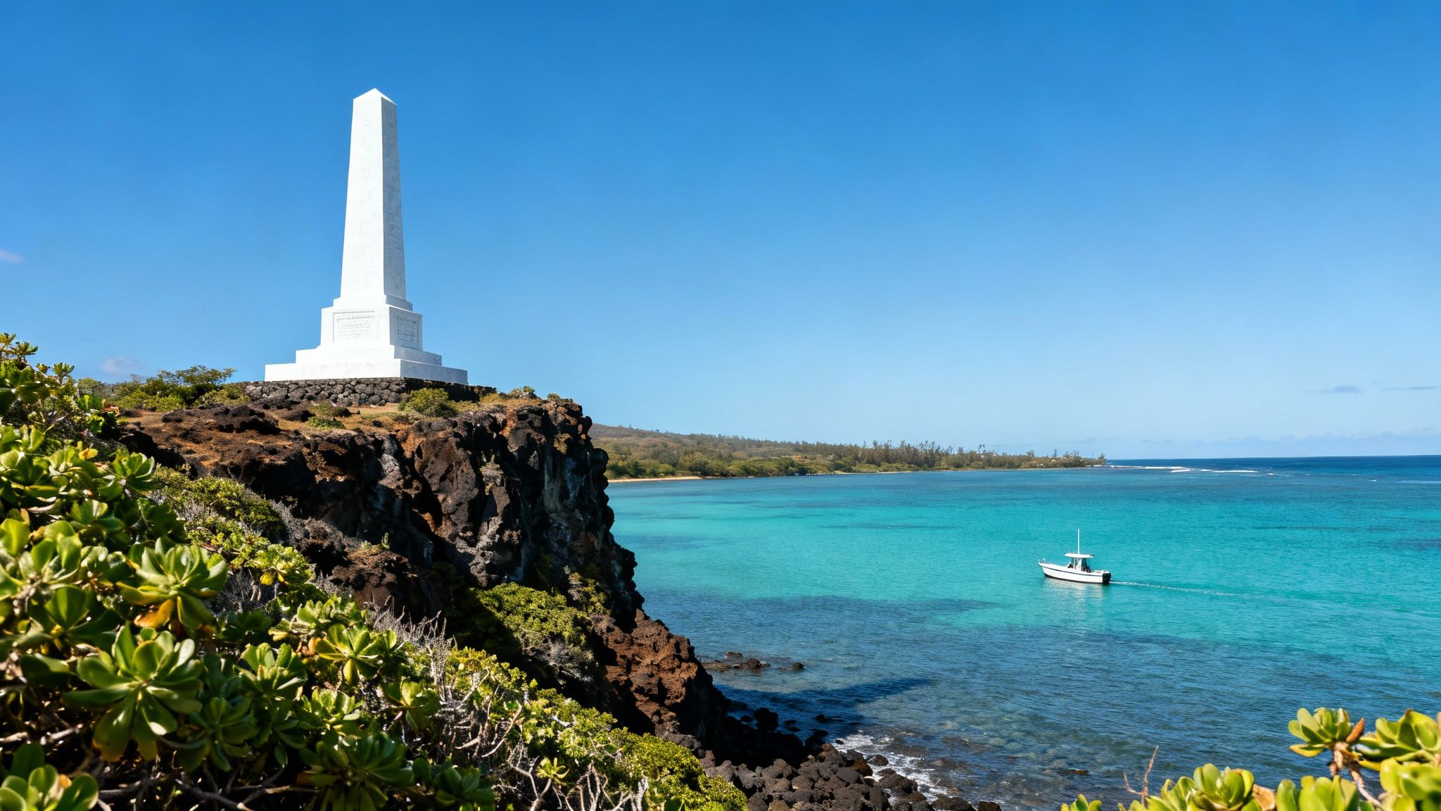 A historic white obelisk monument stands on a cliff overlooking a vibrant turquoise ocean with a boat.