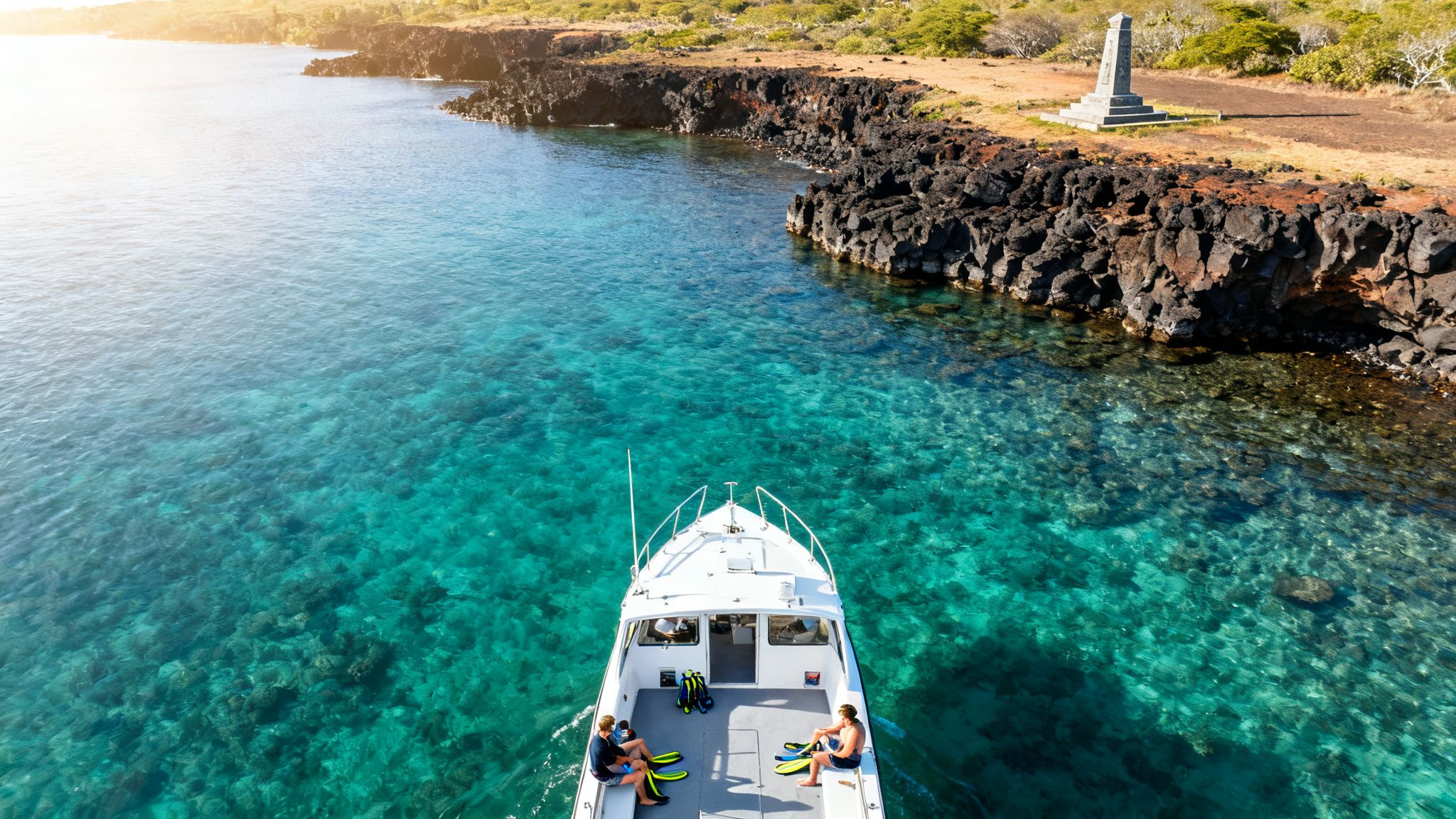 Aerial view of a boat with snorkelers in clear turquoise water near a rocky coastline.